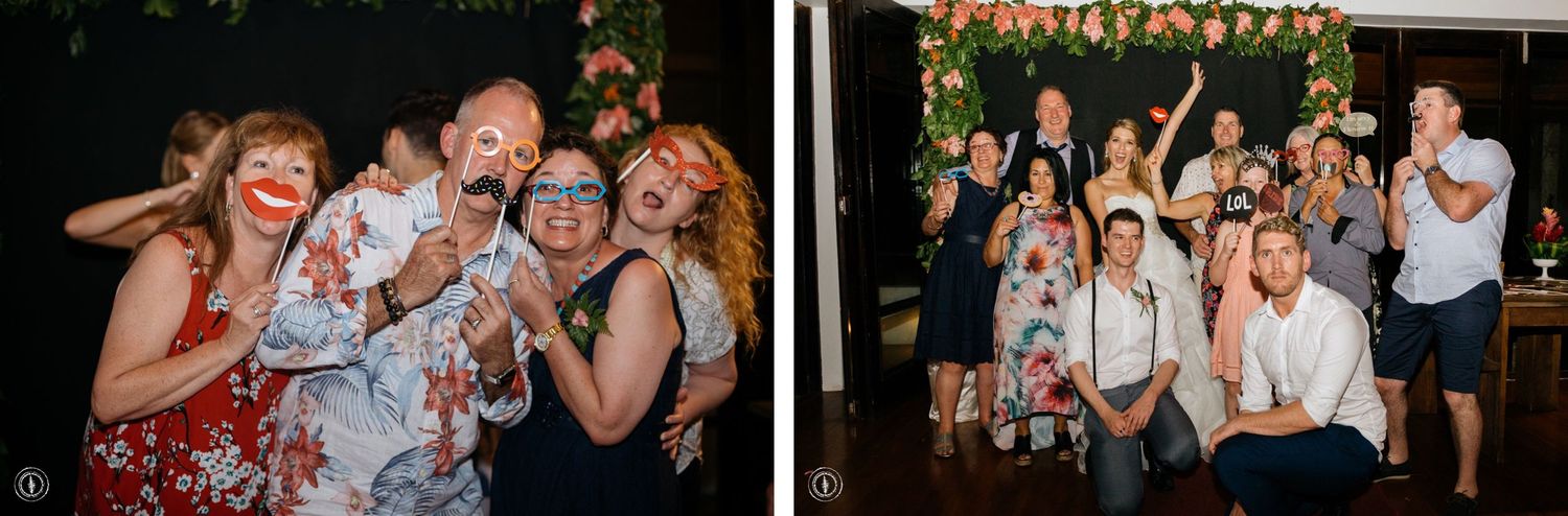 Wedding party guests posing and celebrating at a joyful reception event.