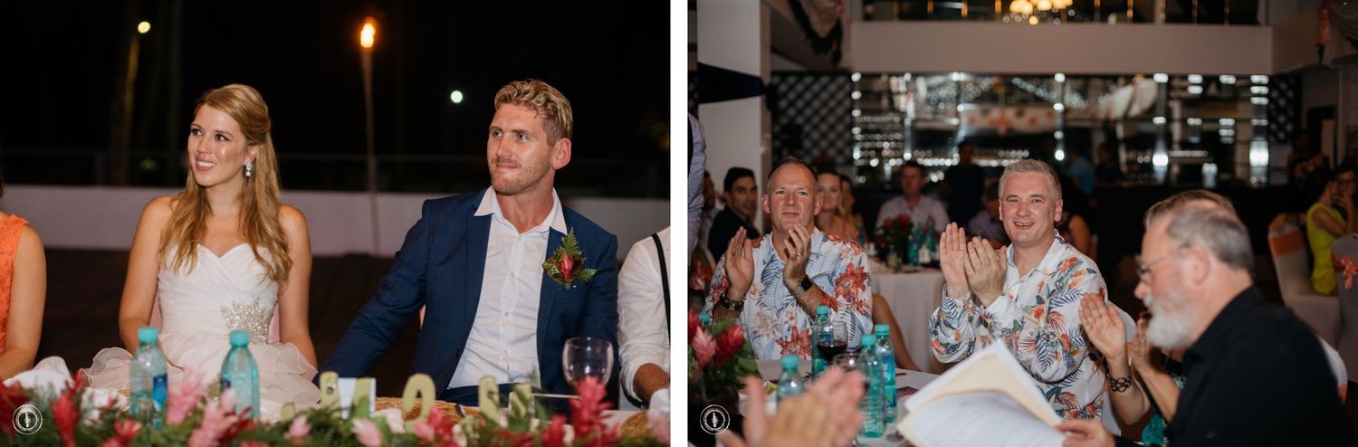 Wedding reception dinner scene with guests seated at decorated tables in an indoor venue.