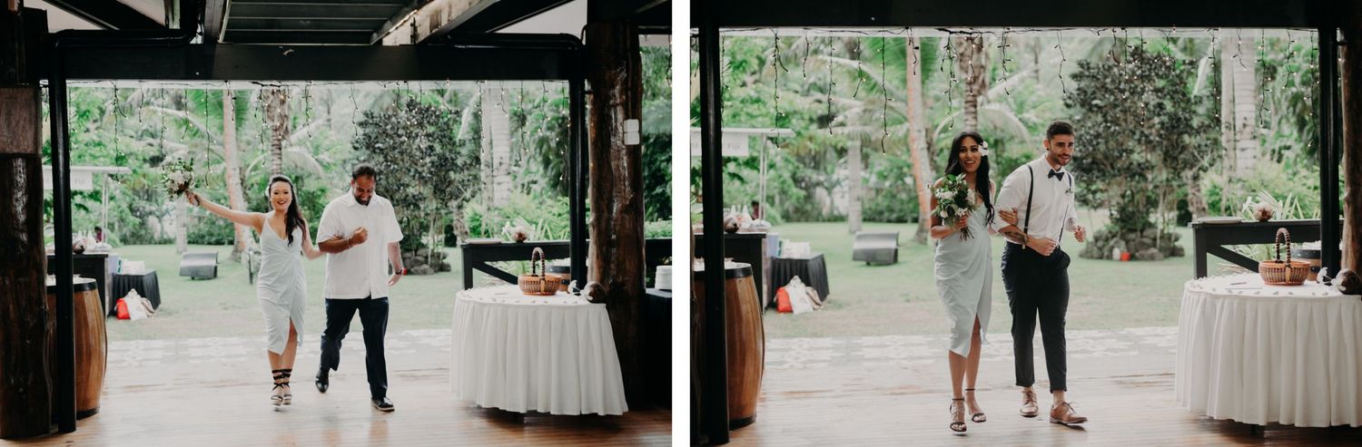 Wedding reception space with dark wooden beams and white tables set against a backdrop of tropical forest.