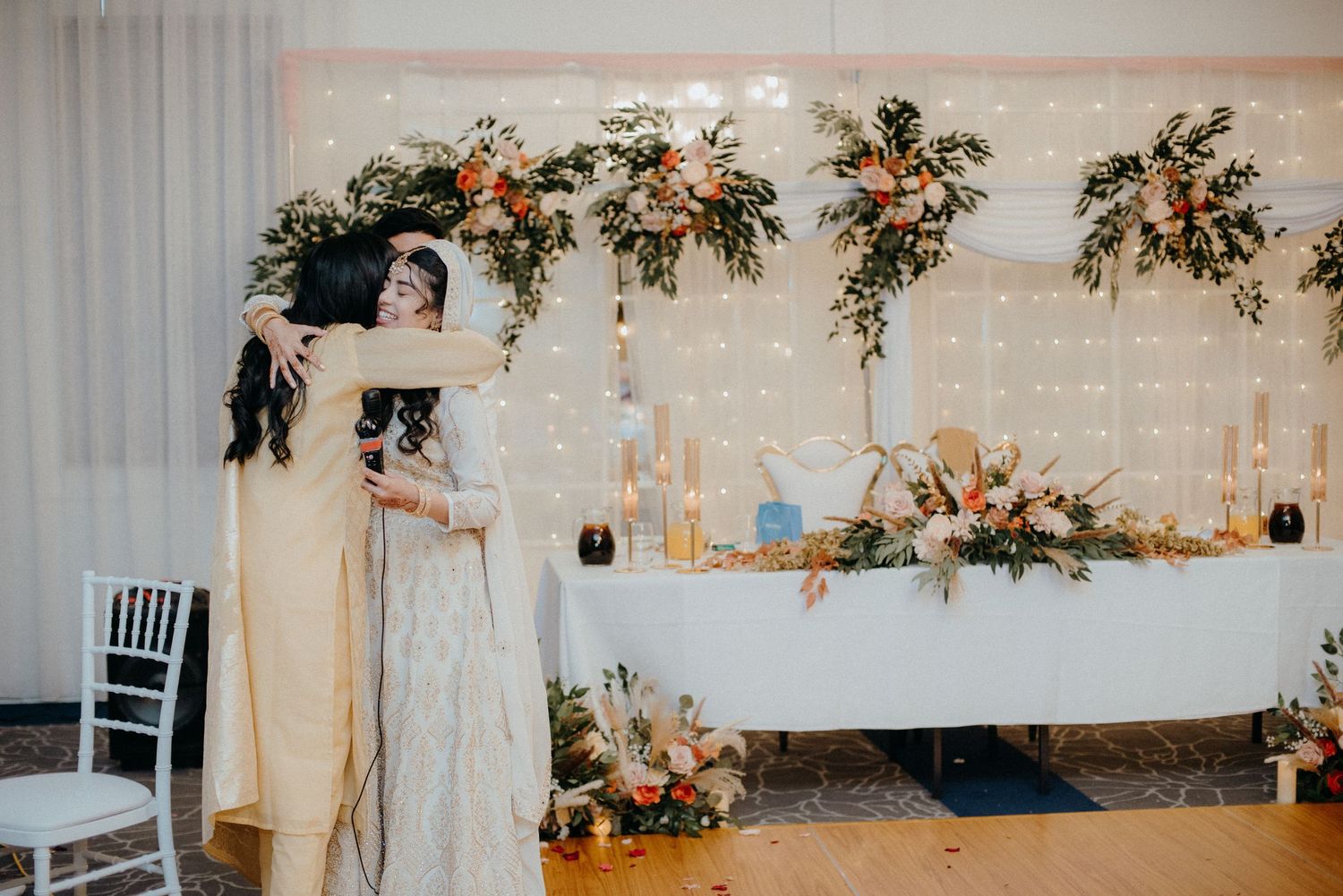 Wedding reception venue decorated with elegant floral arrangements and fairy lights.