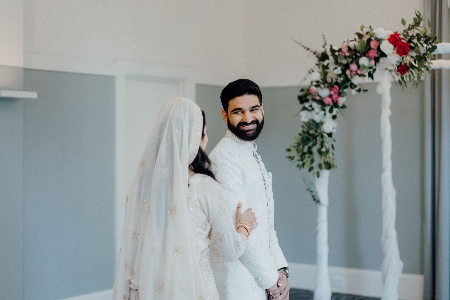 An elegant wedding venue decorated with floral arrangements and white columns for a traditional ceremony.
