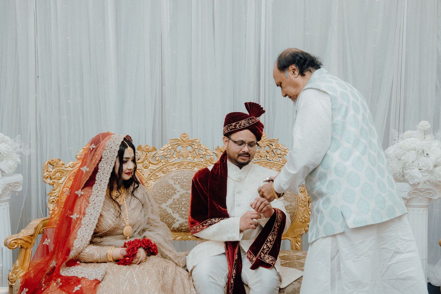Cultural wedding ceremony moment with traditional attire and decor.