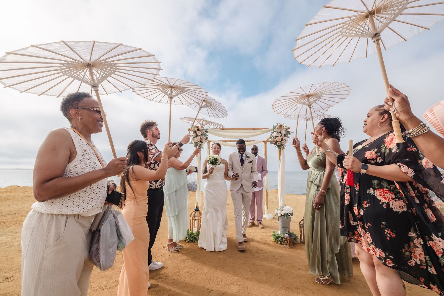 San Diego Sunset Cliffs wedding photography by Jenny Thai Photography -  biracial mixed couple just married under umbrellas