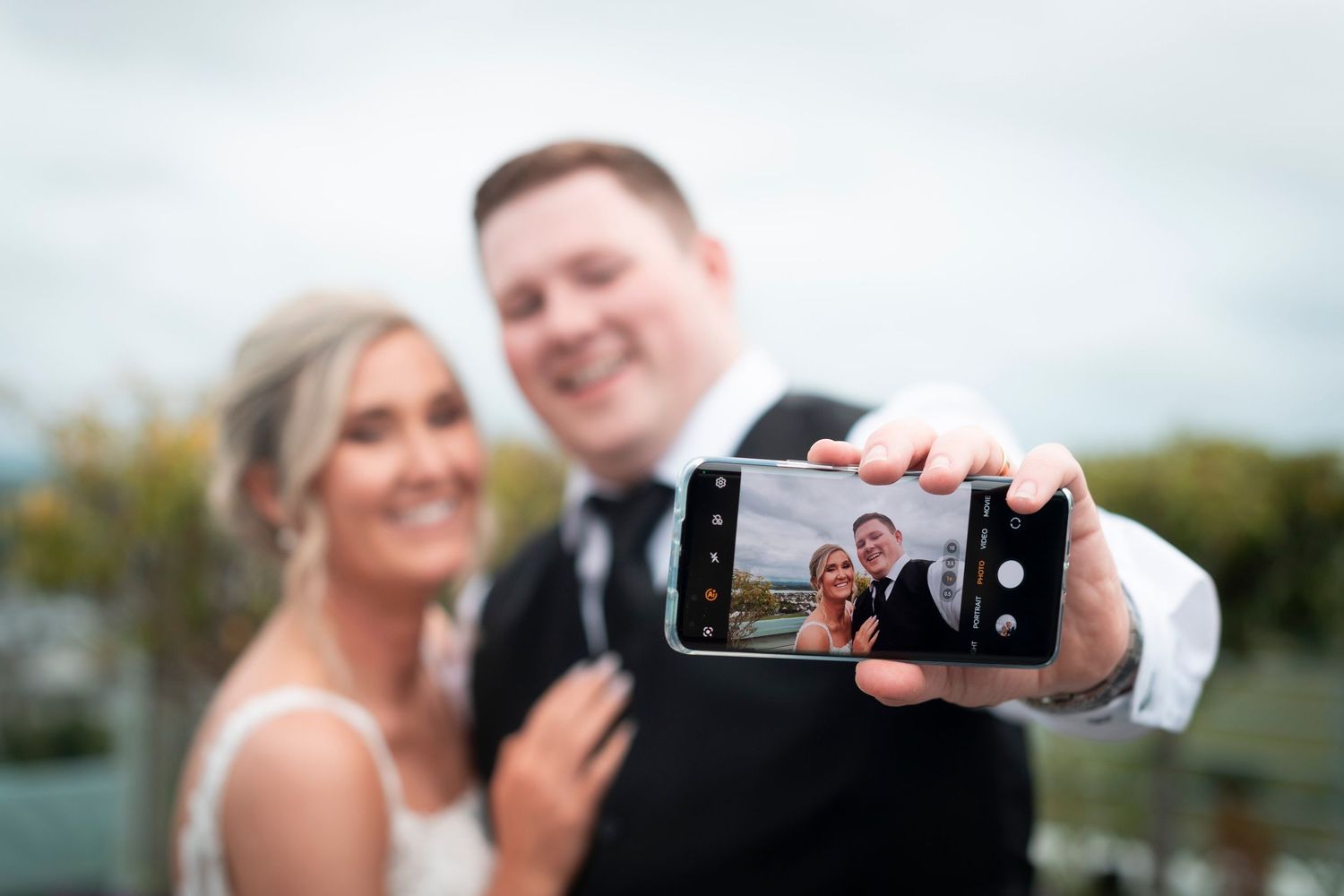 A couple takes a selfie together during their wedding celebration.