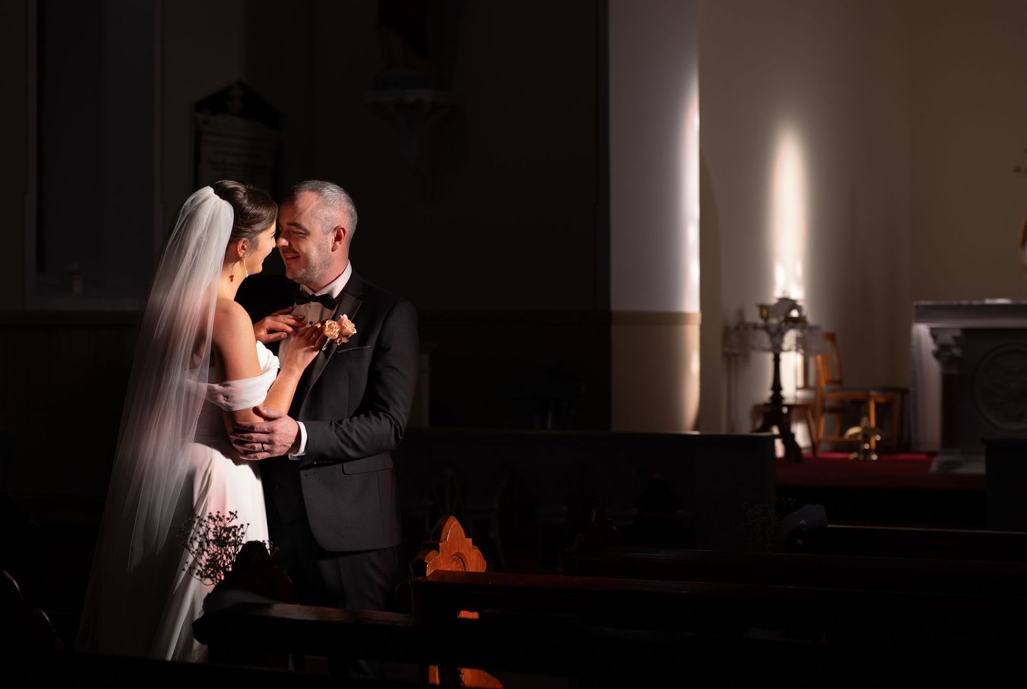 Artistic wedding portraits using dramatic lighting and shadows.