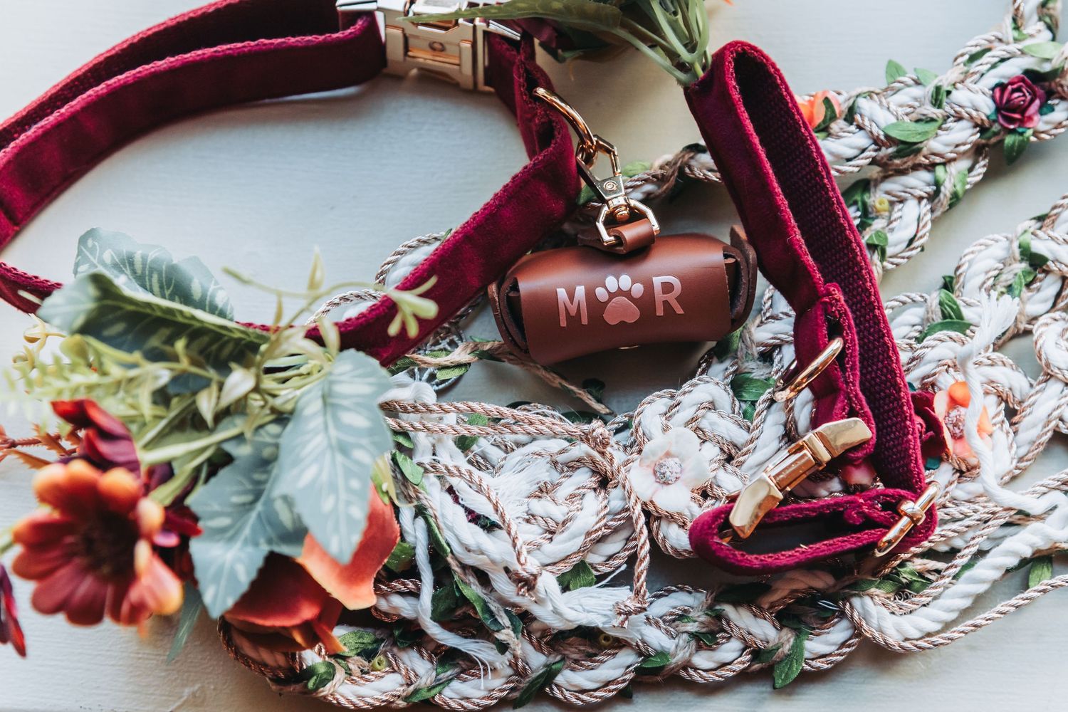 Wedding accessories including a burgundy velvet collar with floral details and heart charm.