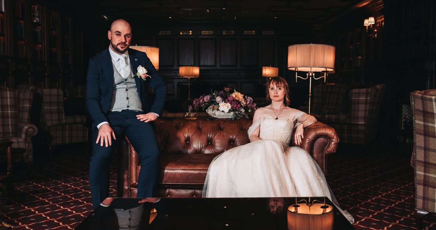 Atmospheric wedding photography in a dimly lit venue with romantic ambient lighting.