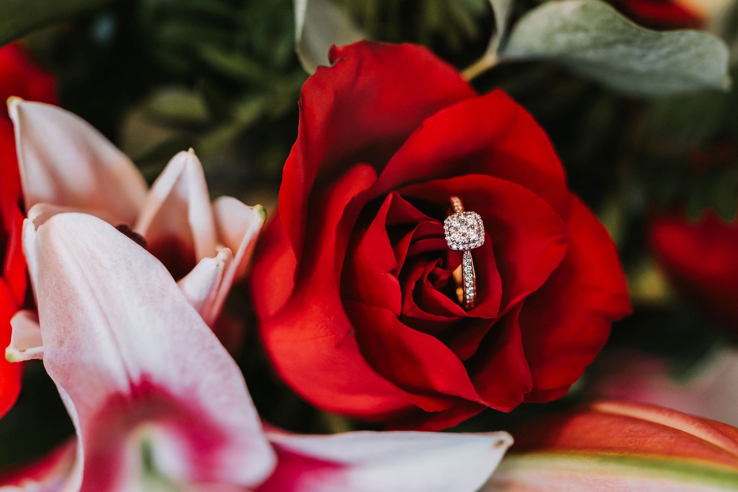 Beautiful red roses and pink flowers with wedding ring arranged as wedding decorations.