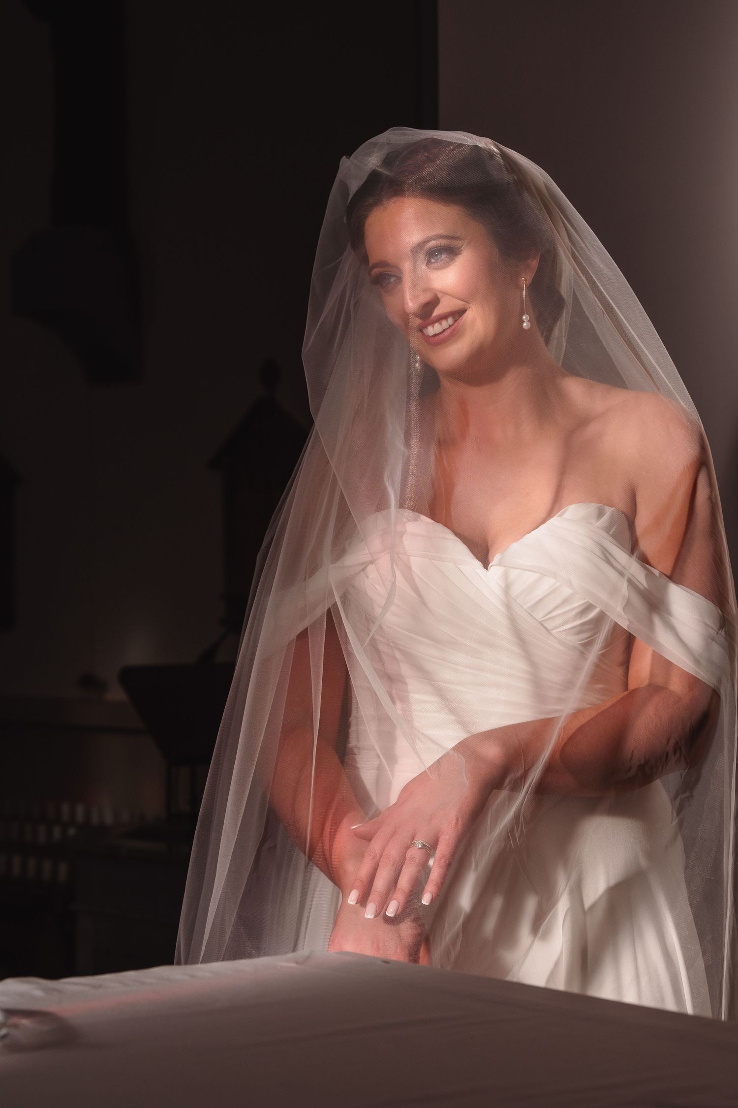 A flowing white wedding dress and veil captured in a series of dreamy, artistic bridal portraits.
