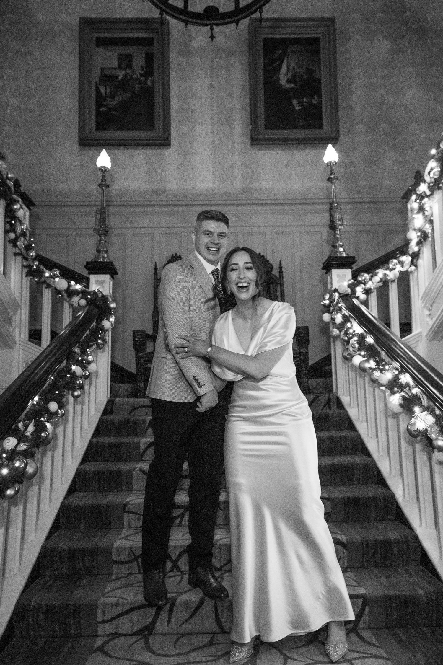 A sequence of five black and white wedding photos showing a couple dancing and celebrating in a decorated venue.