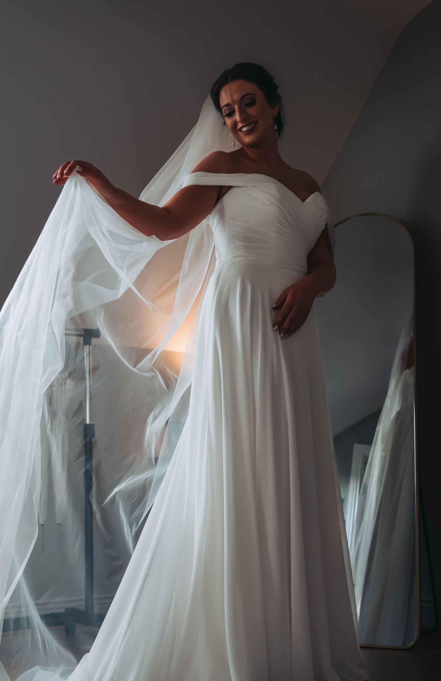 An elegant white wedding gown with flowing fabric shown in multiple romantic angles.