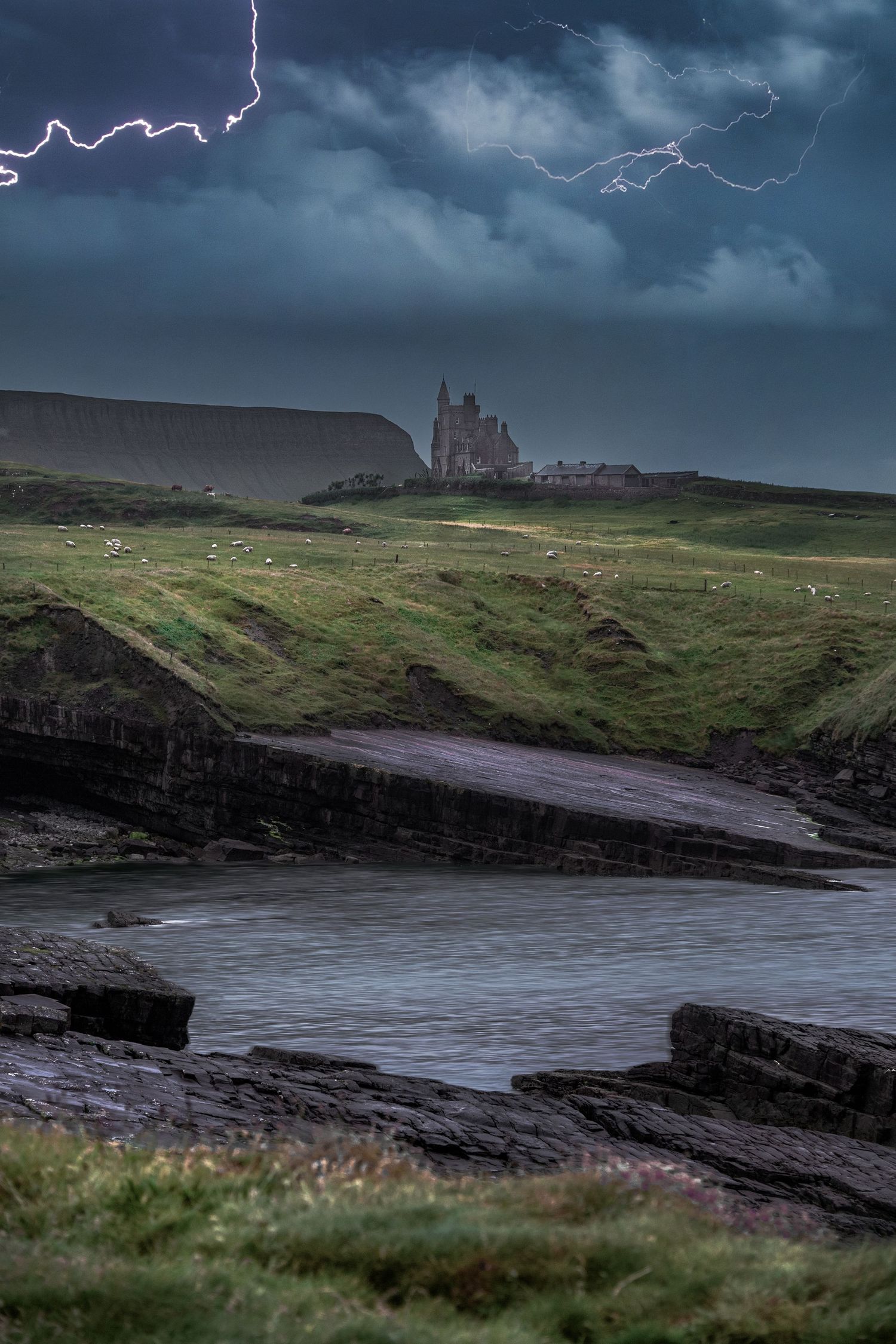 Lightning strikes over a dramatic stormy coastline with ancient castle ruins on a green Irish cliff.