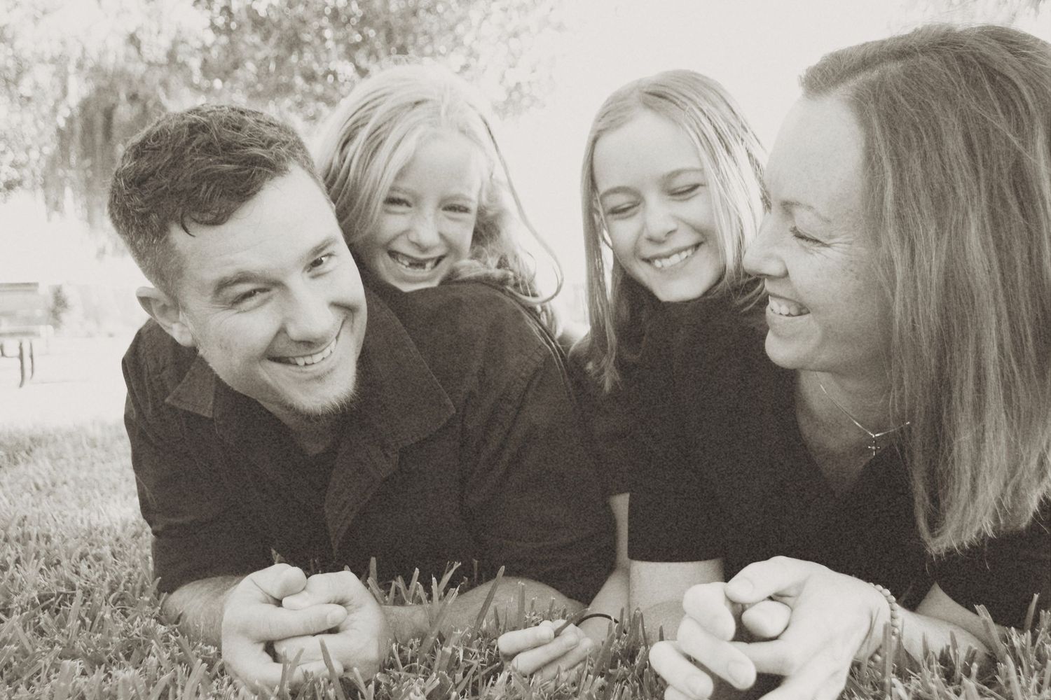 A collection of black and white photographs showing people laughing and smiling together in candid moments.