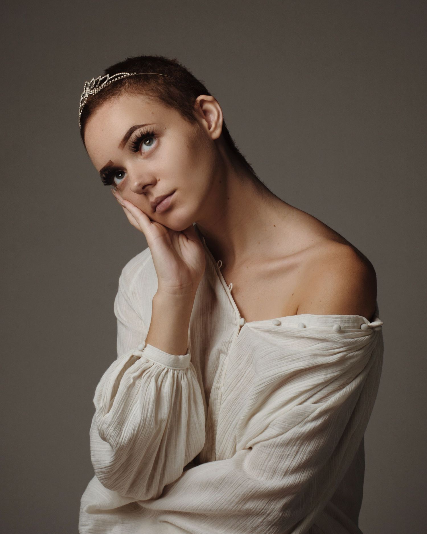 Ethereal portraits featuring off-shoulder white peasant blouse in moody studio lighting.