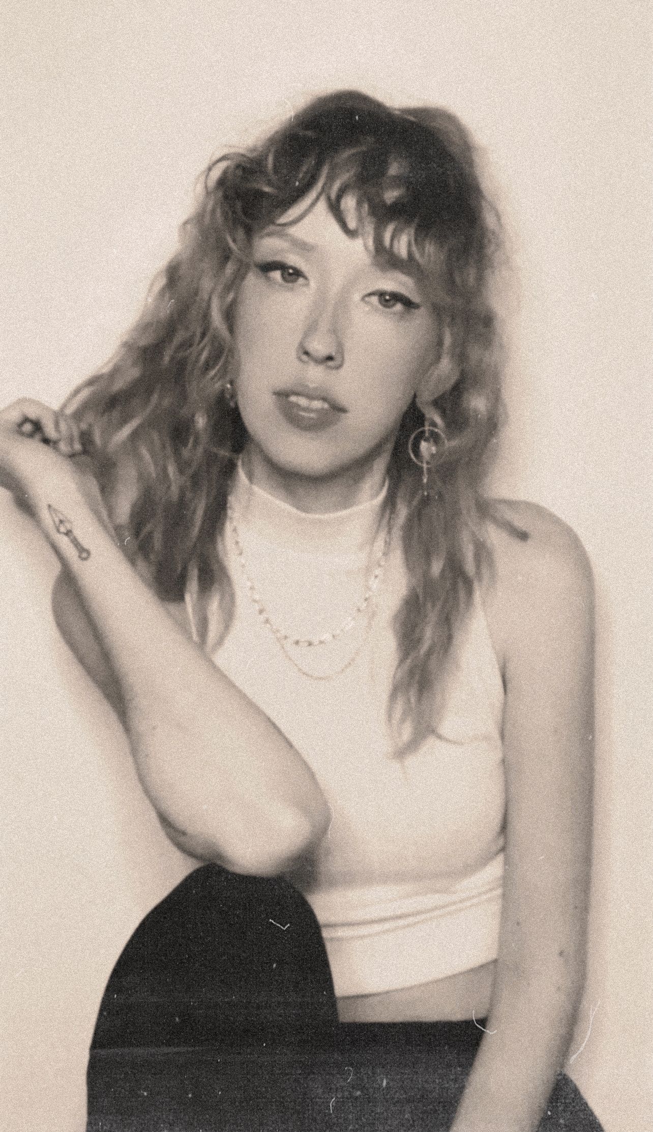 Vintage style portrait series with cream background and casual styling.