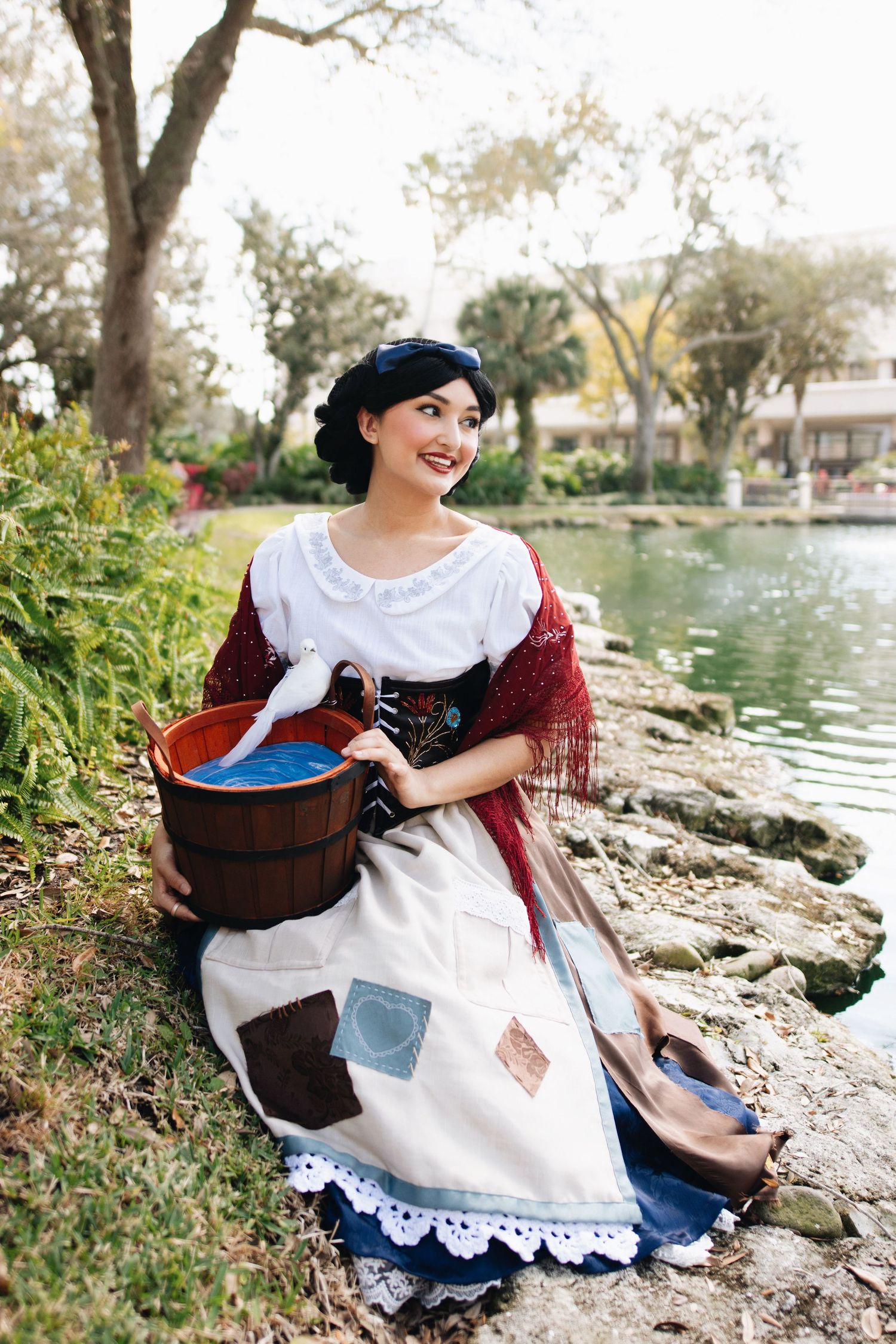 A historical reenactment scene showing laundry washing by a pond.
