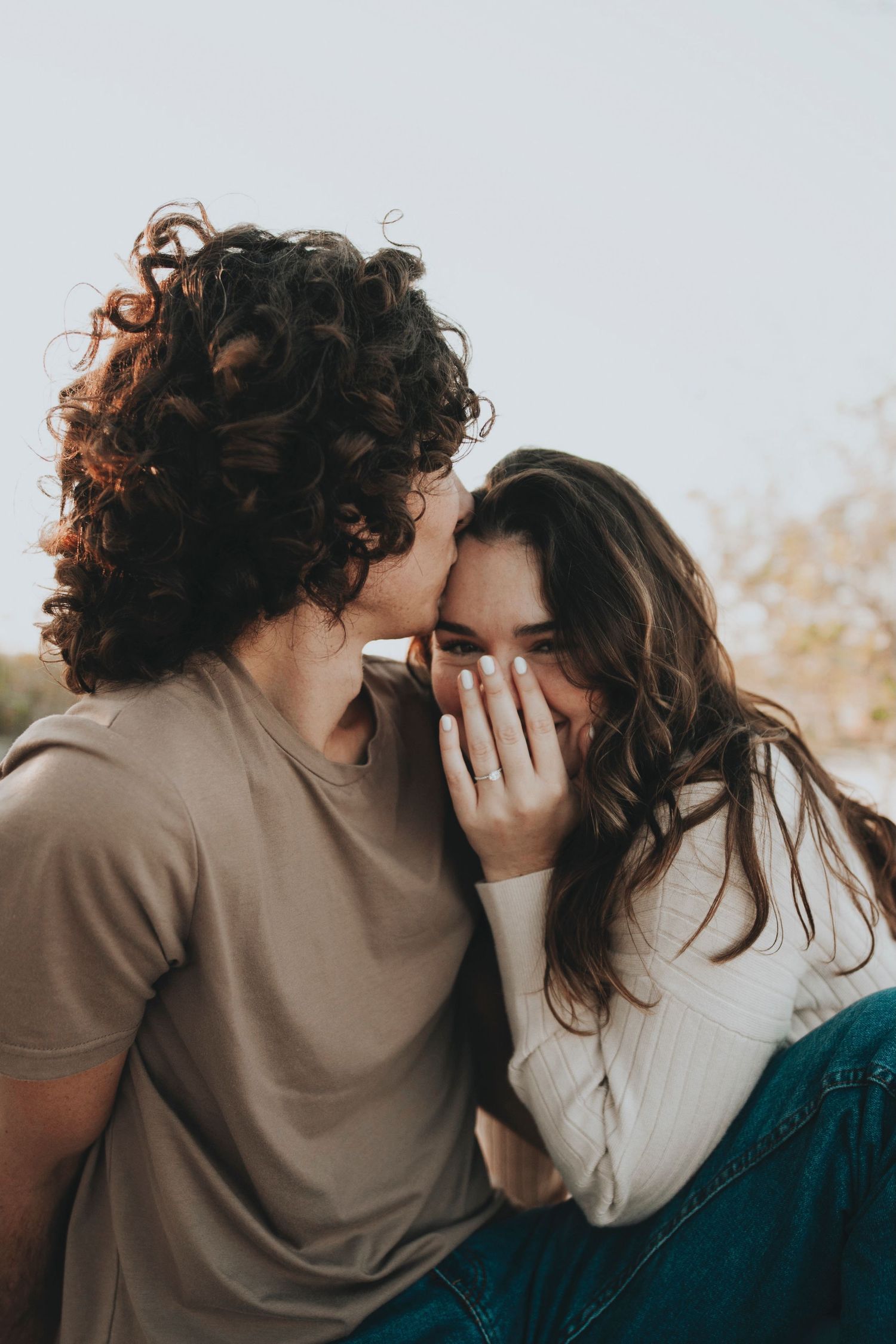 Intimate couple portrait with warm lighting and natural expressions.