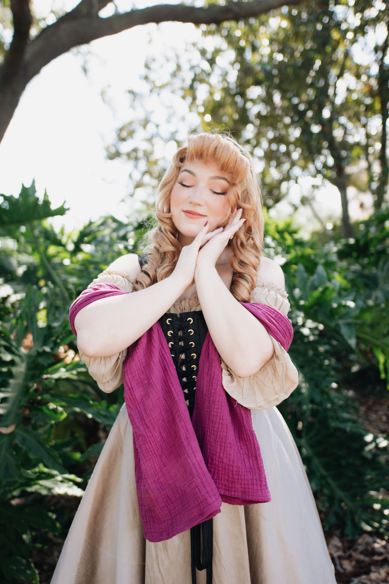 Whimsical poses in vintage costume with hands near face in garden setting.