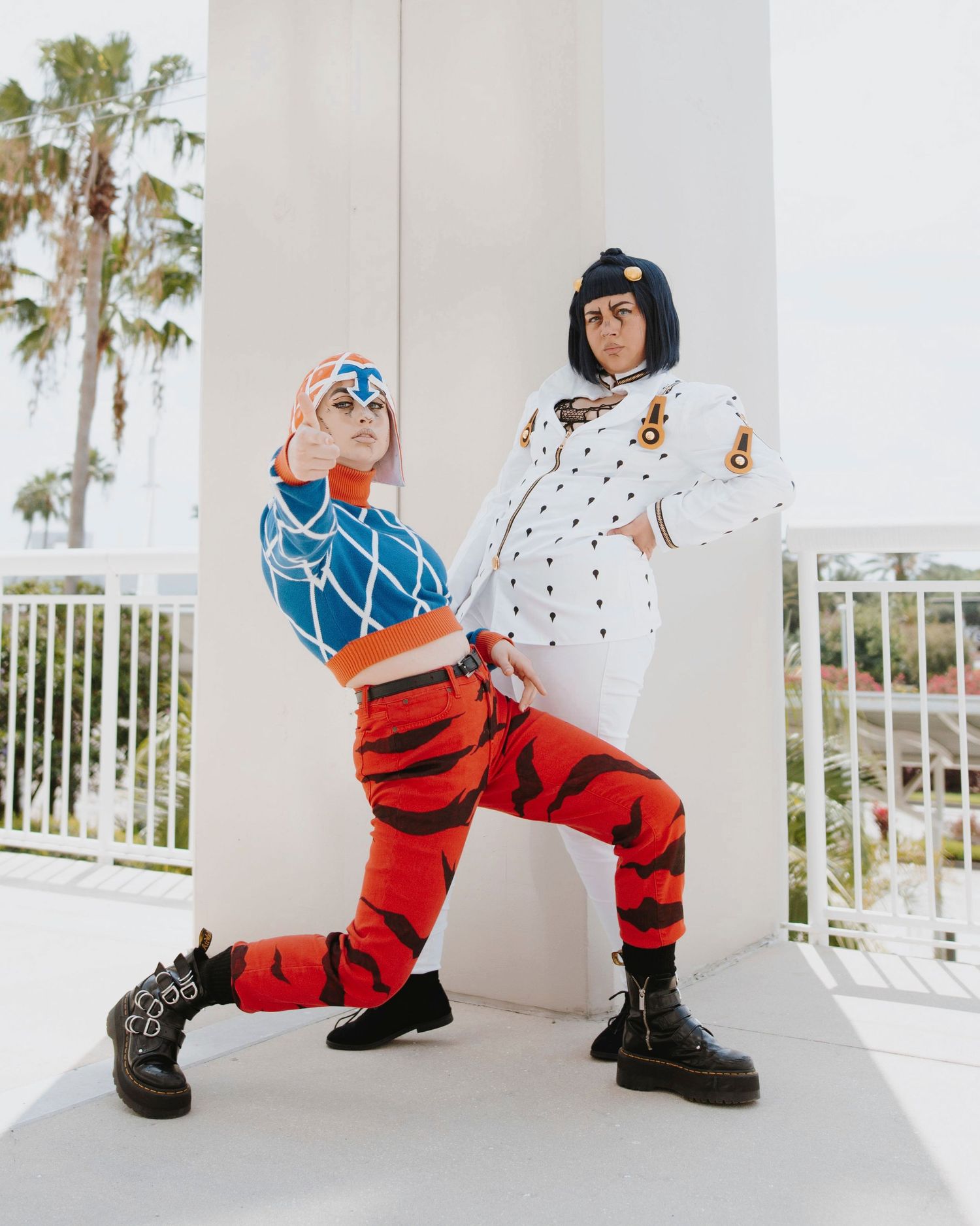 Dynamic poses in red and white streetwear outfit with blue accents against white background.