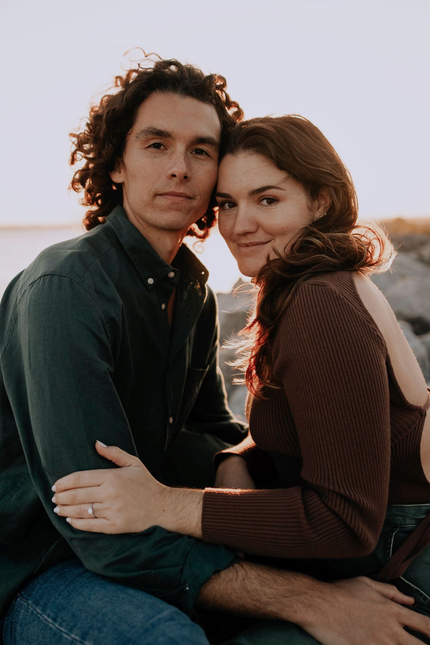 Romantic autumn portrait session showing tender embrace against soft lighting.