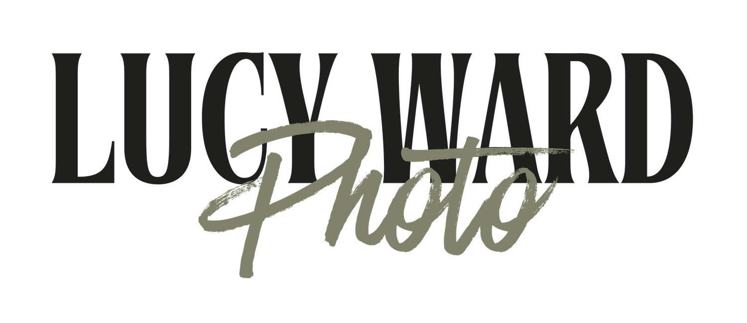 Lucy Ward Photo logo featuring bold black serif text with elegant olive green cursive script accent.