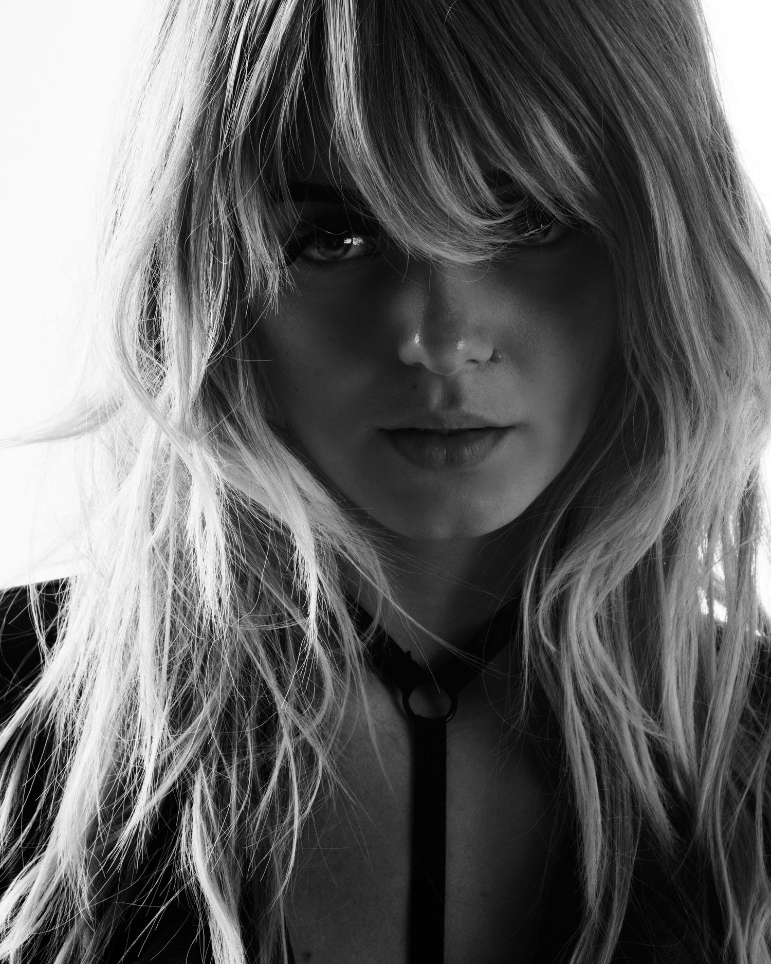 High contrast black and white portrait series with dramatic lighting and shadows.