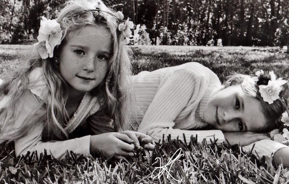 Series of artistic black and white photos showing girls lying in grass and nature settings.