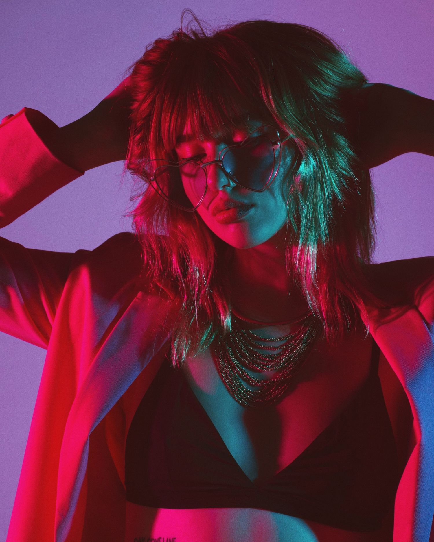 Dynamic fashion portraits with red and blue lighting effects creating dramatic contrast.