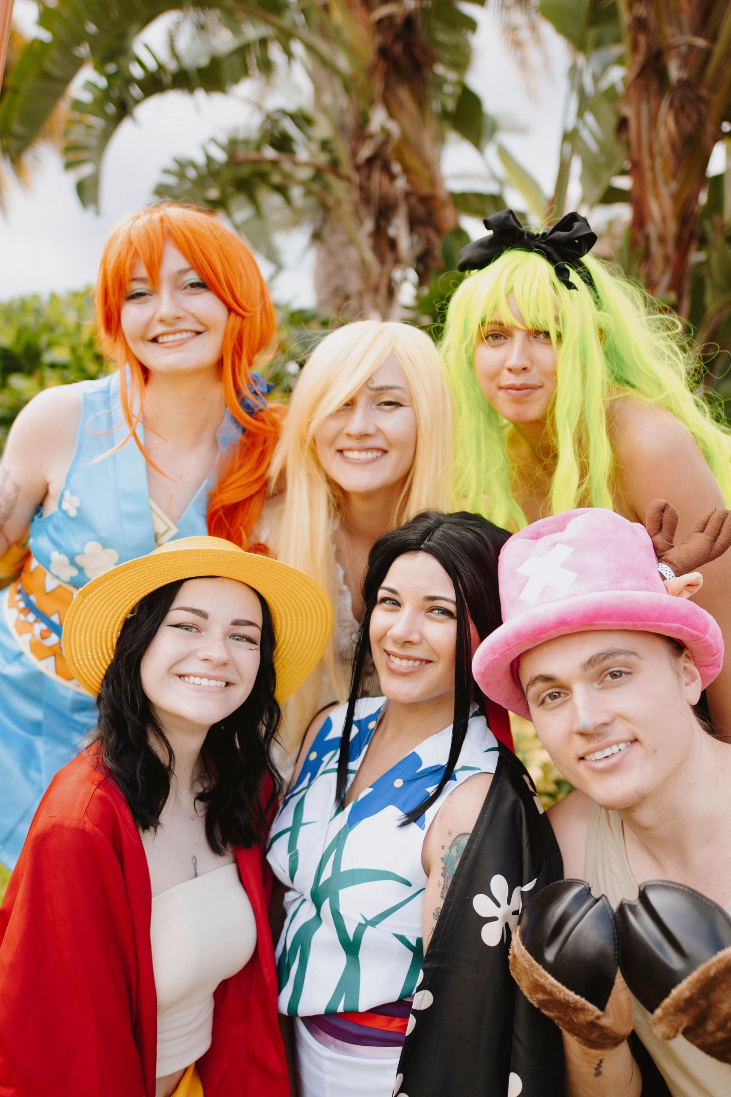 Group cosplay photo featuring colorful wigs and various anime-inspired outfits.