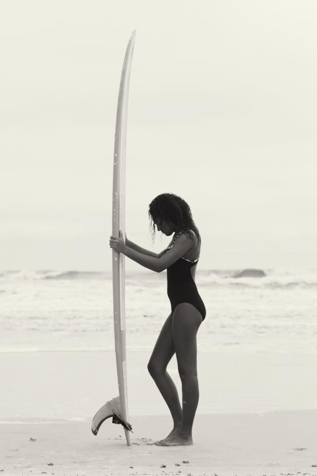 Series of black and white beach photos showing silhouette poses with a surfboard.