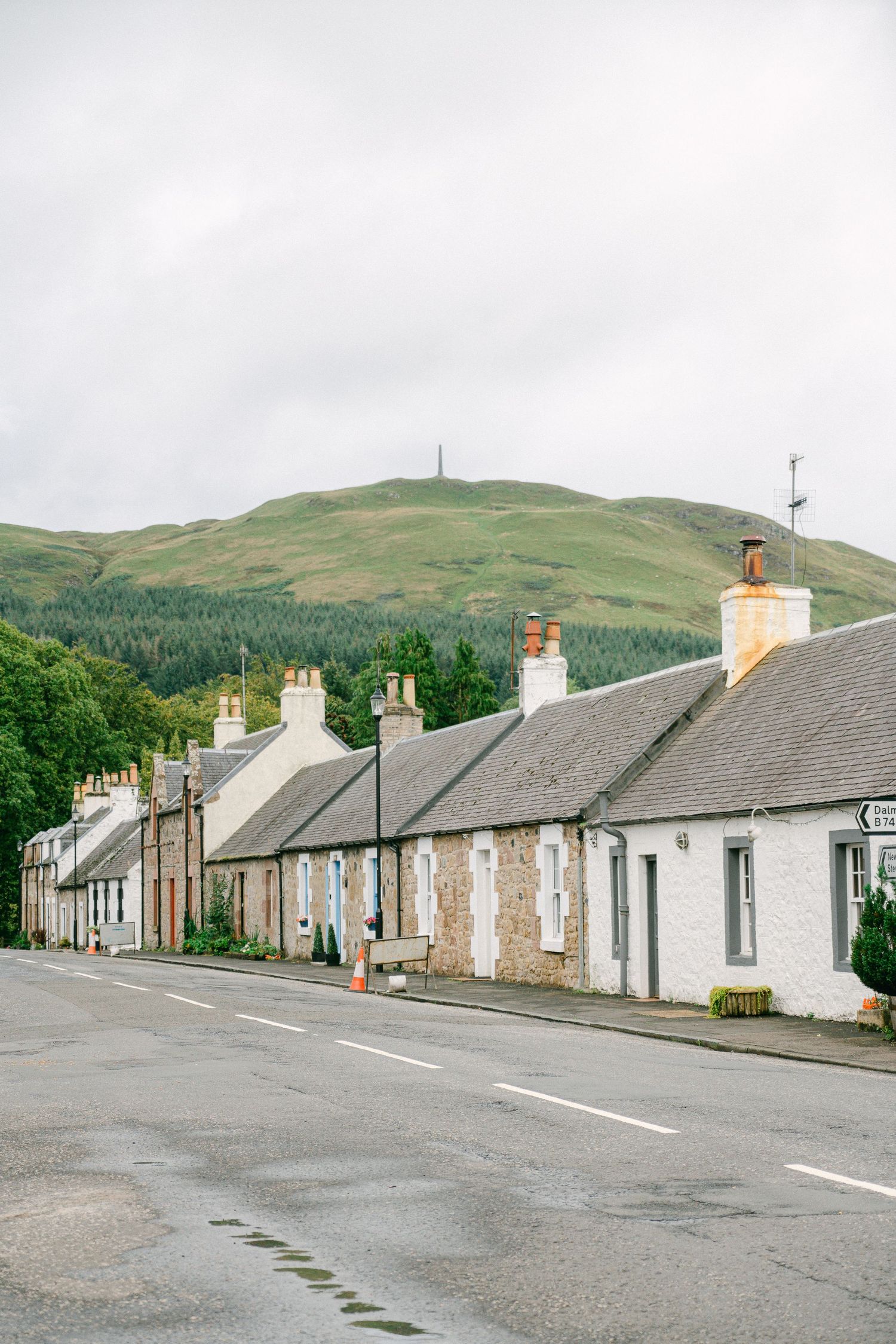 Row of traditional Irish stone cottages line a quiet village street in the rolling hills of rural Ireland,  micro wedding planning tips NC