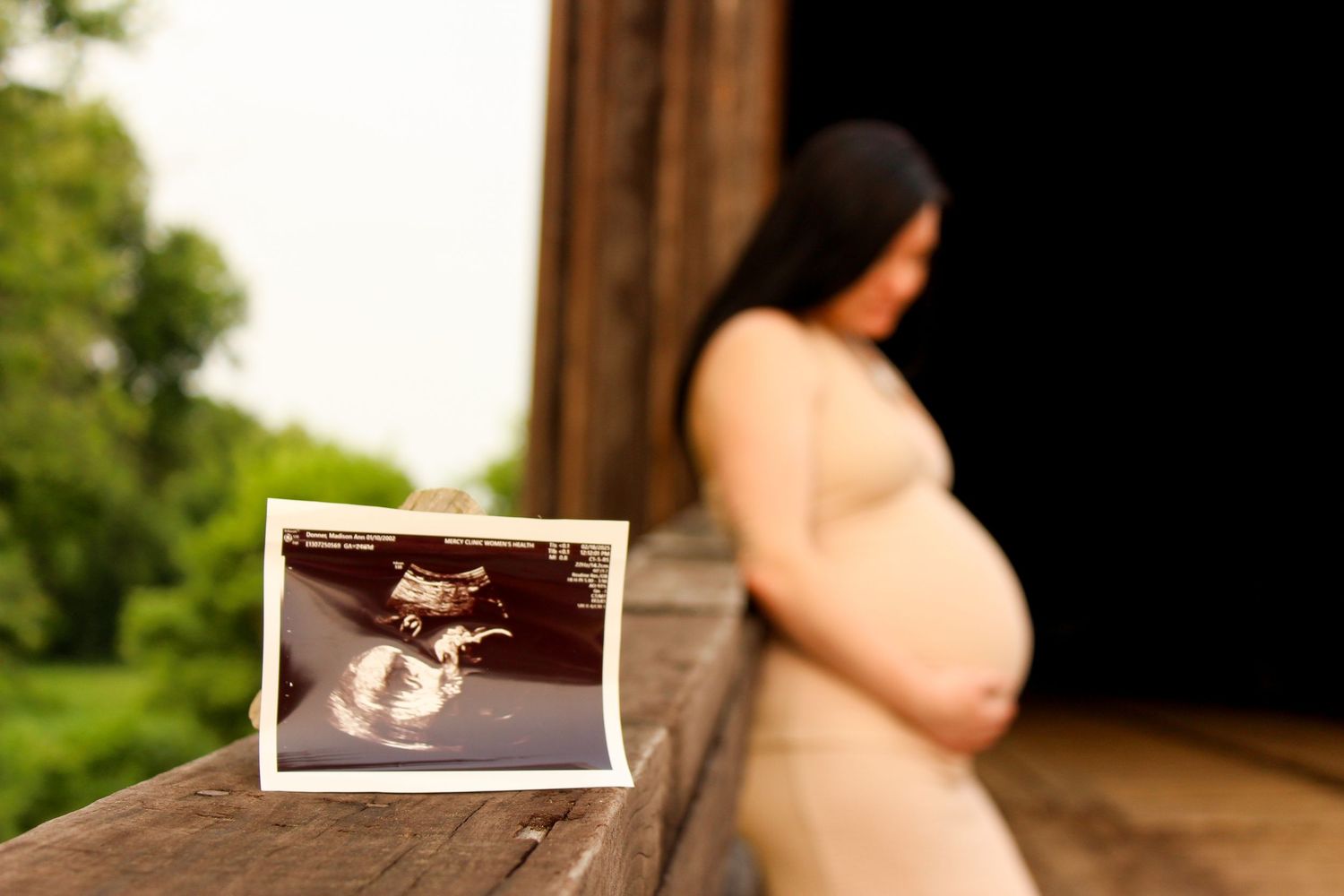 A series of maternity photos showing a pregnant woman in a white dress posing outdoors in natural lighting.