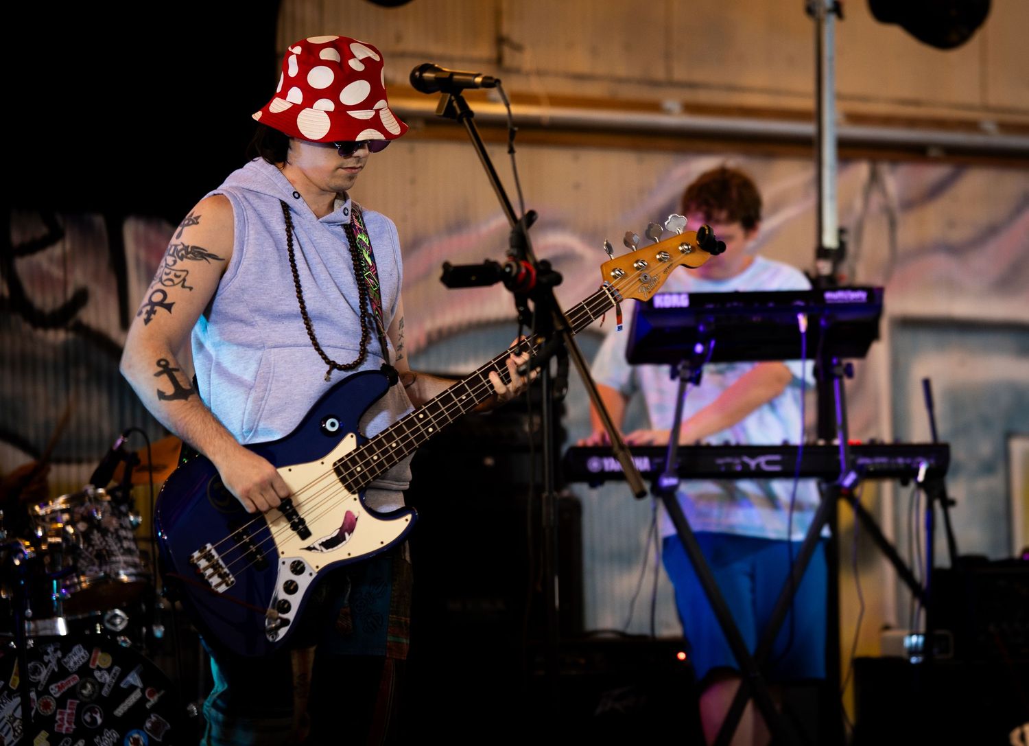 Musicians perform on stage with guitars and instruments during a live concert performance.