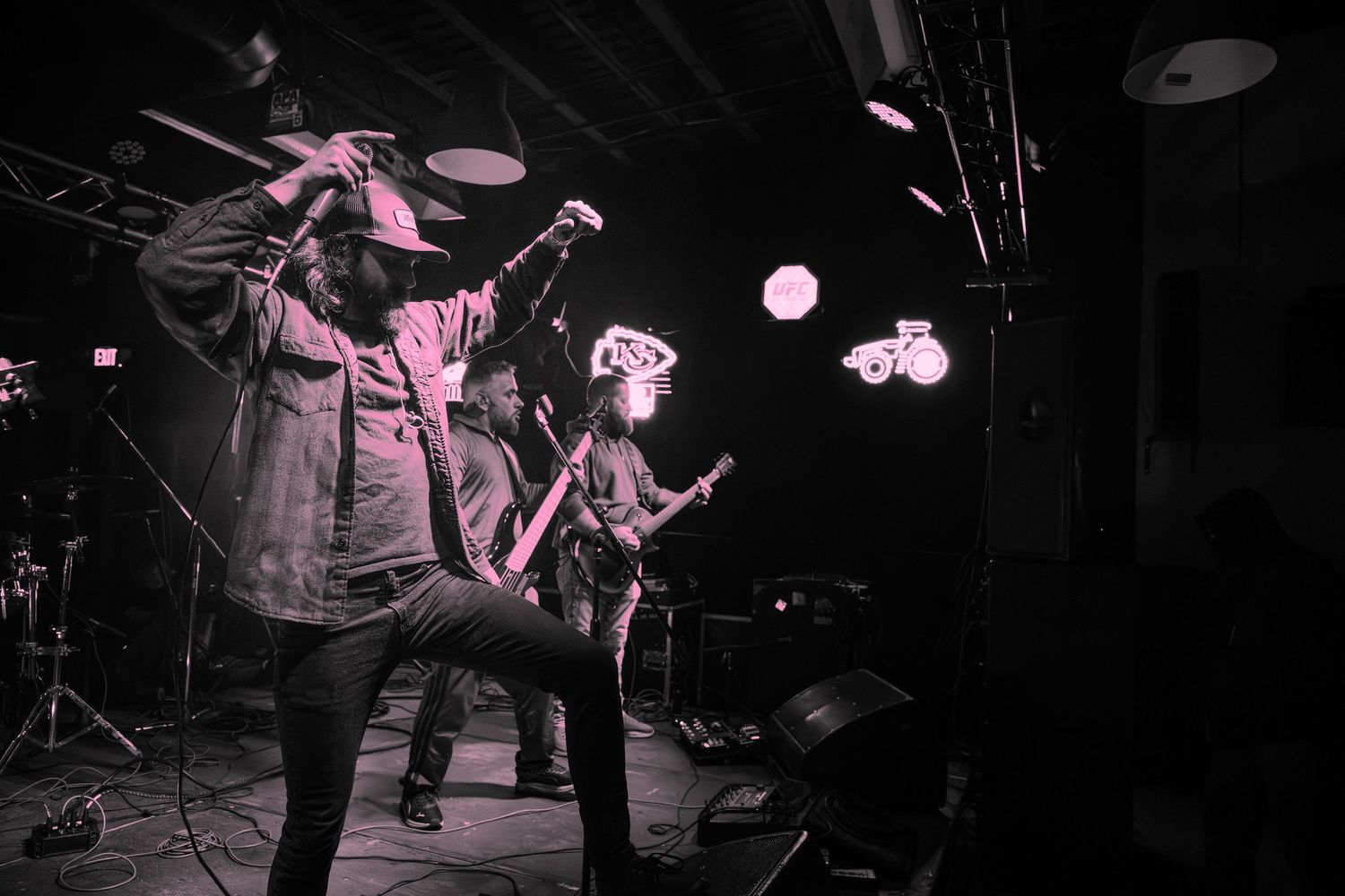 Black and white photo series of musicians performing on stage with guitars and instruments during a live concert.