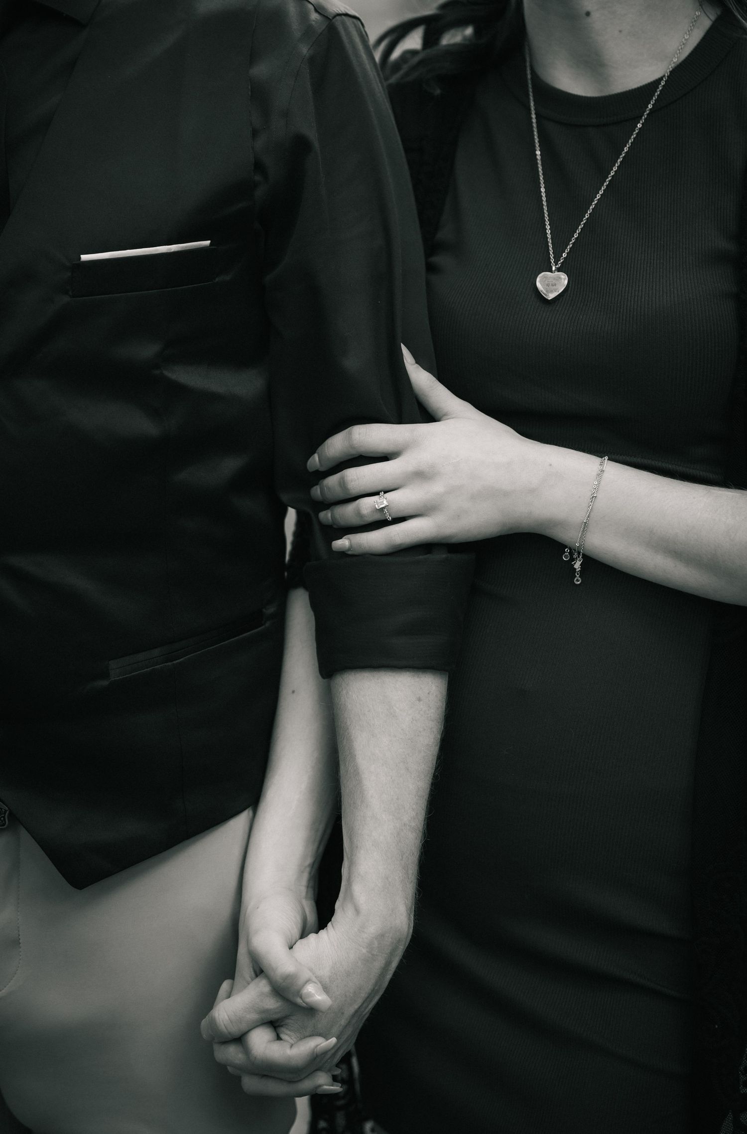 Black and white artistic photo series showing hands in various positions against a dark background.