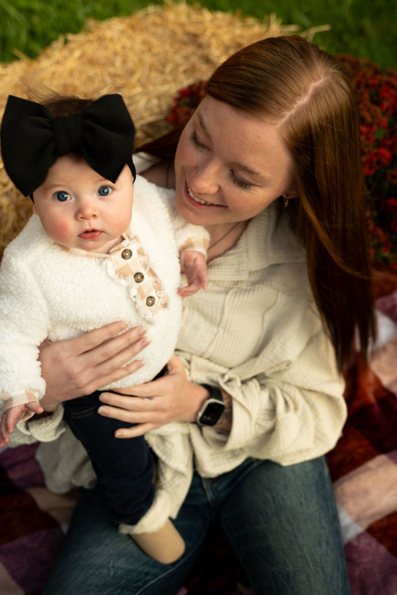 A series of photos showing someone in a white sweater holding a cream-colored cat on their lap in an outdoor setting.