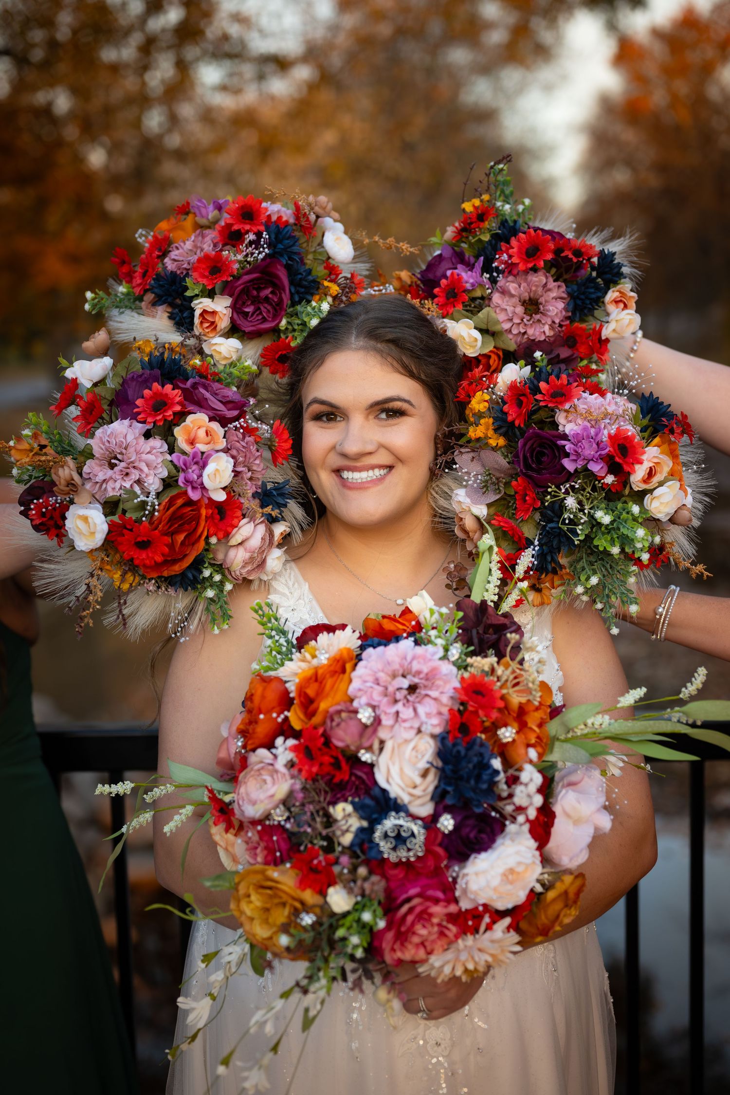 Vibrant floral crown and bouquet arrangement featuring colorful autumn blooms.
