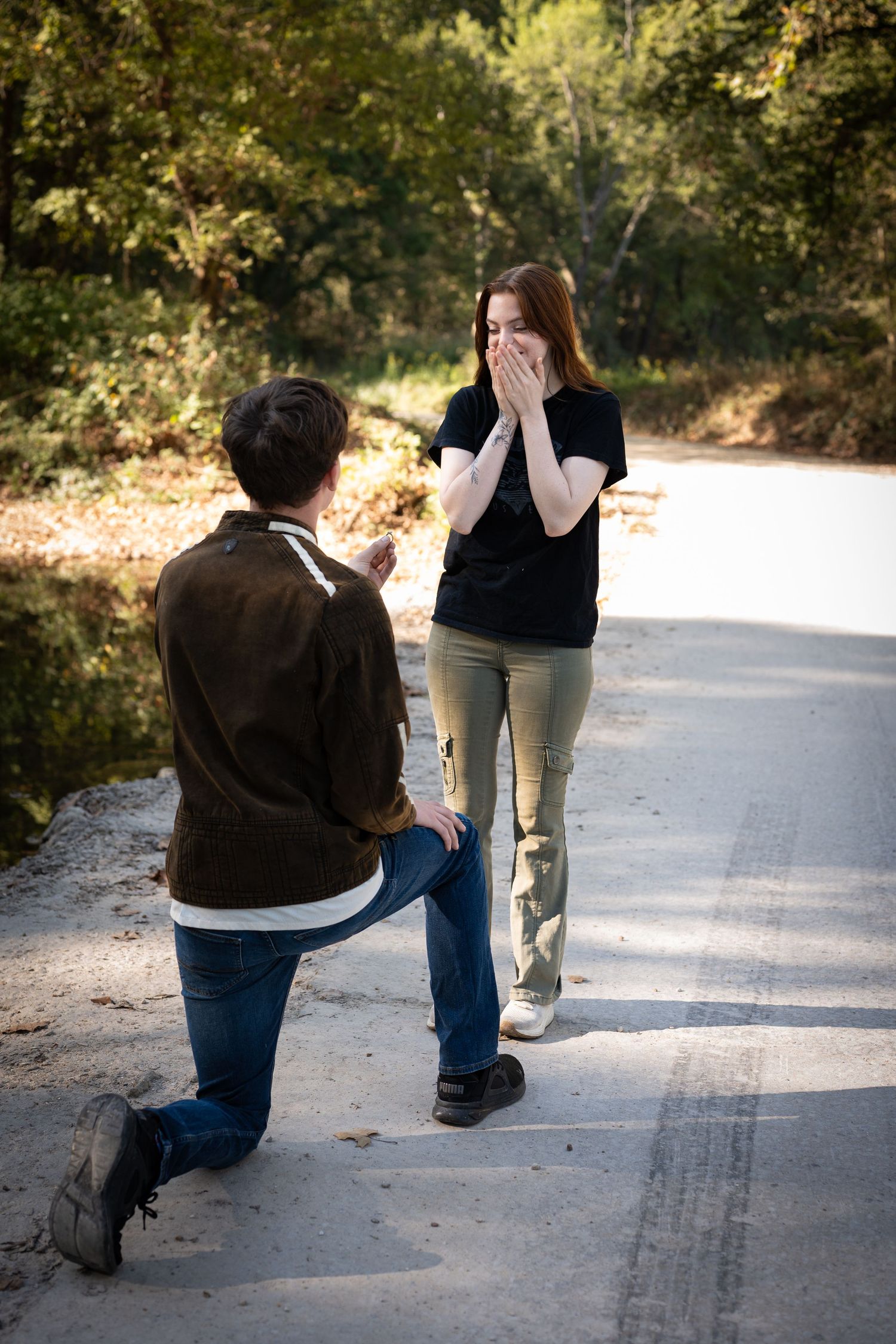 A sequence of photos showing someone kneeling down on a paved path outdoors during a marriage proposal.
