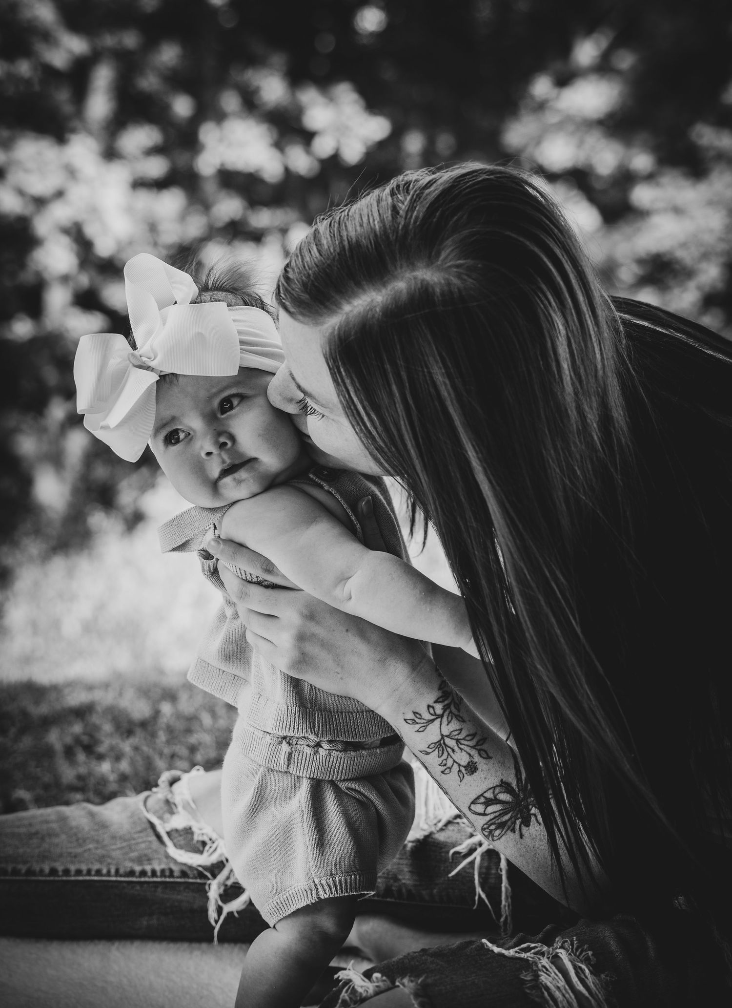 Black and white photo series showing intimate moments between a parent and child in soft natural light.
