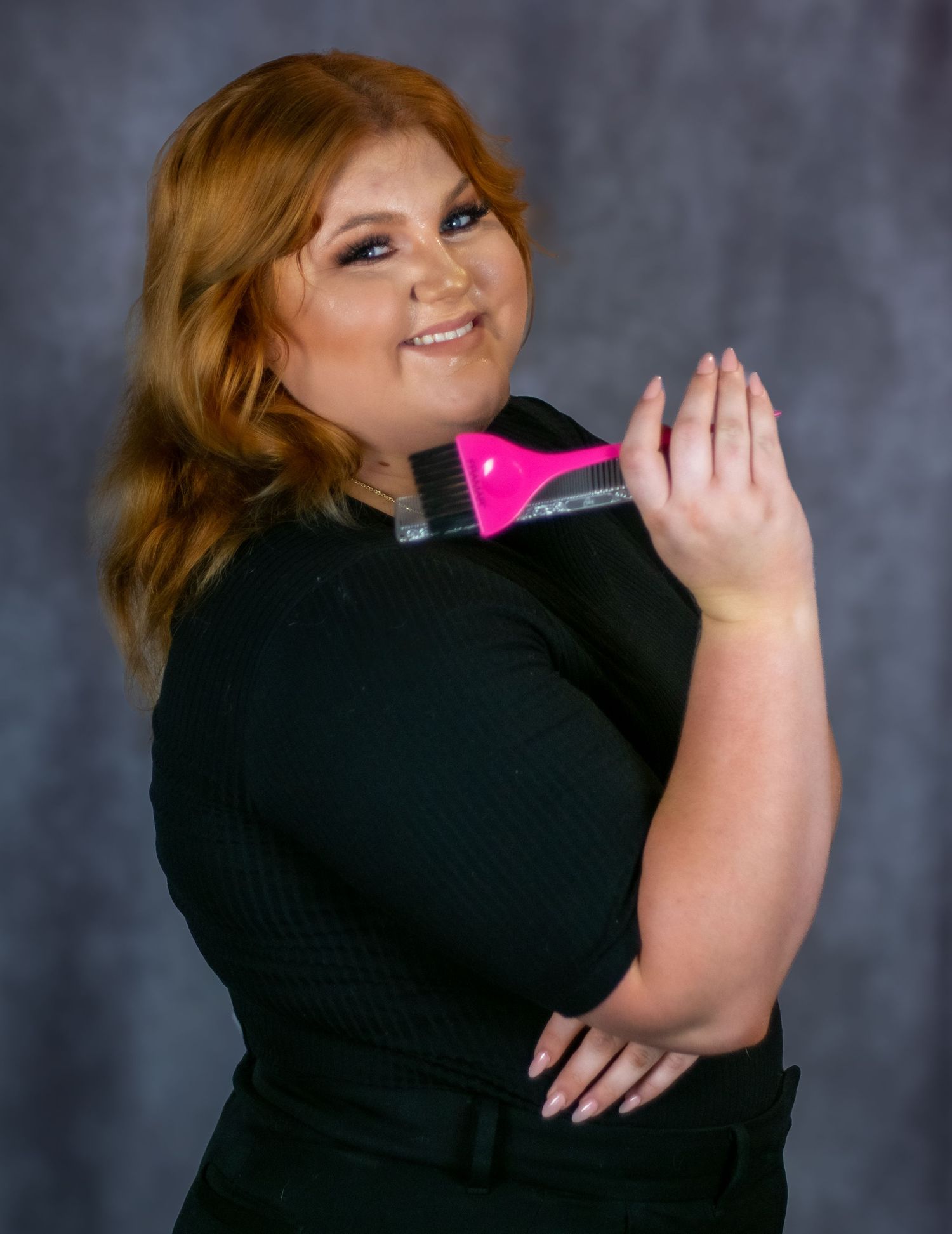 A person in a black sweater poses with a pink phone case against a gray studio backdrop in a four-panel photo series.