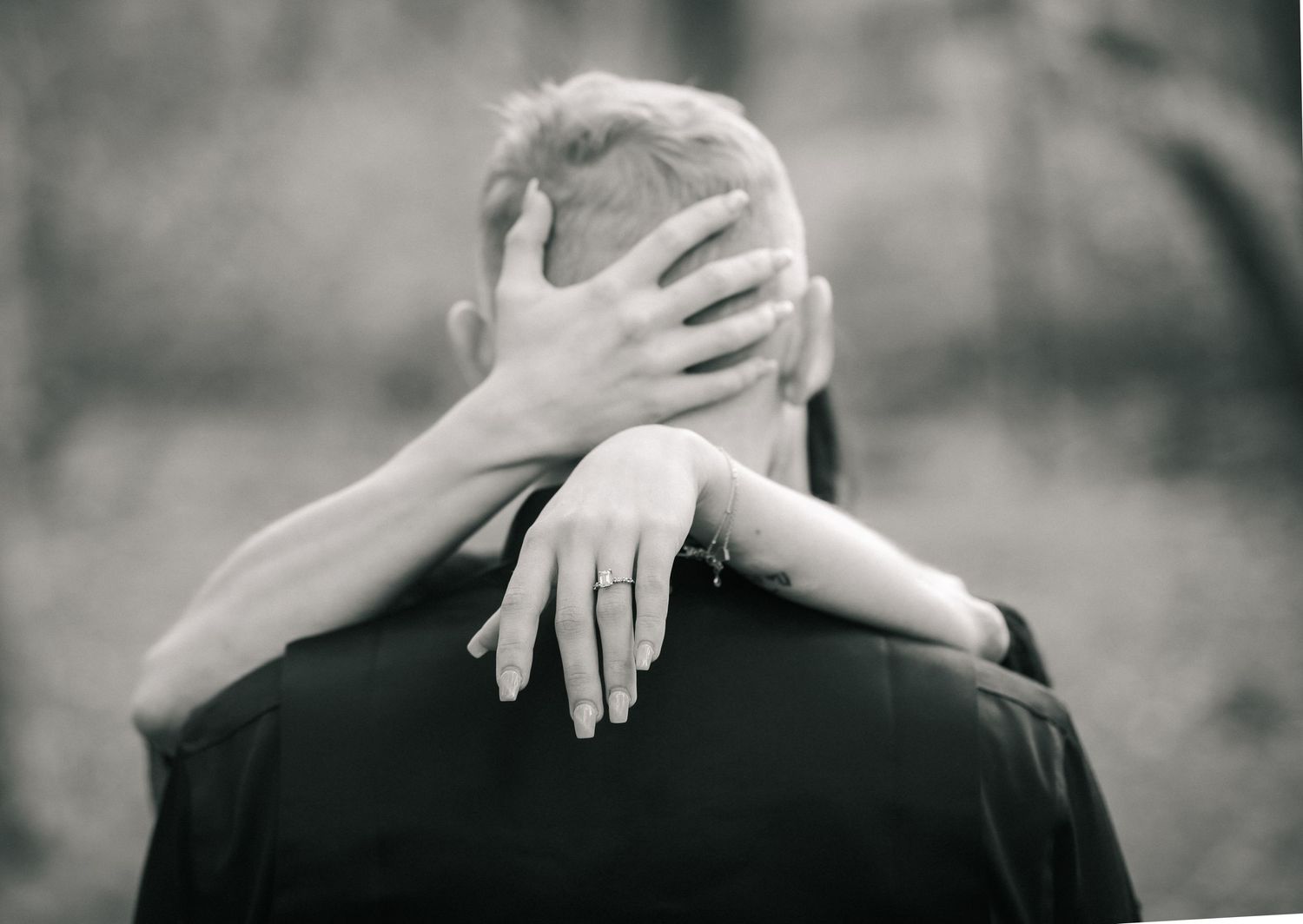 A series of black and white photos showing hands gently touching shoulders in an intimate artistic composition.