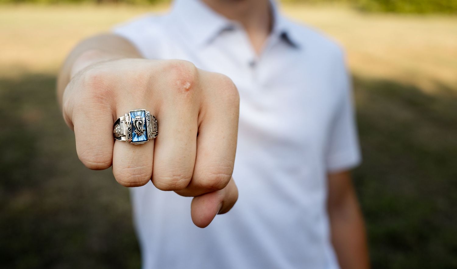 A close-up series showing an engagement ring on a hand against a blurred outdoor background.