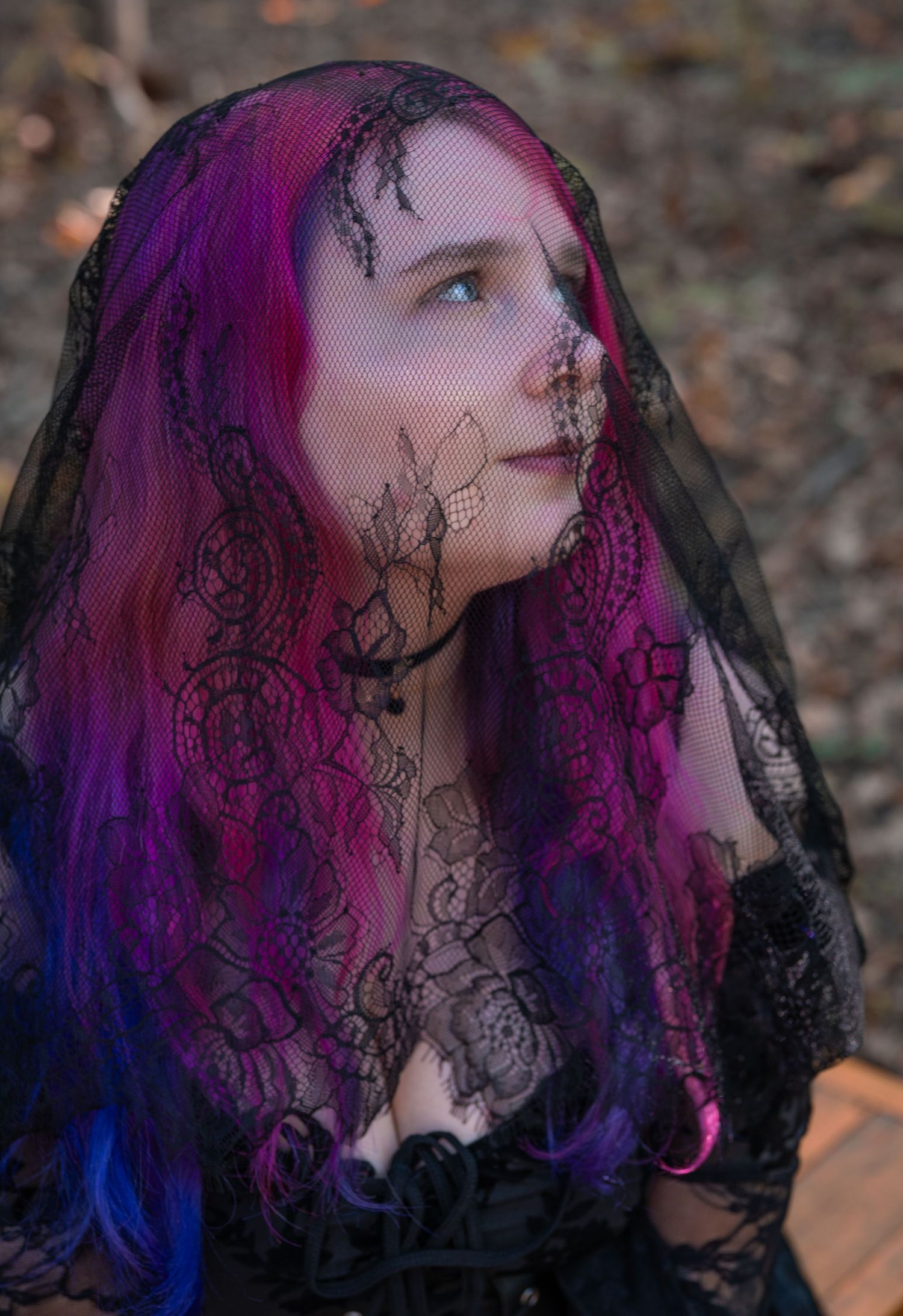 A series of profile shots showing vibrant purple and blue hair under black lace veil in moody outdoor lighting.