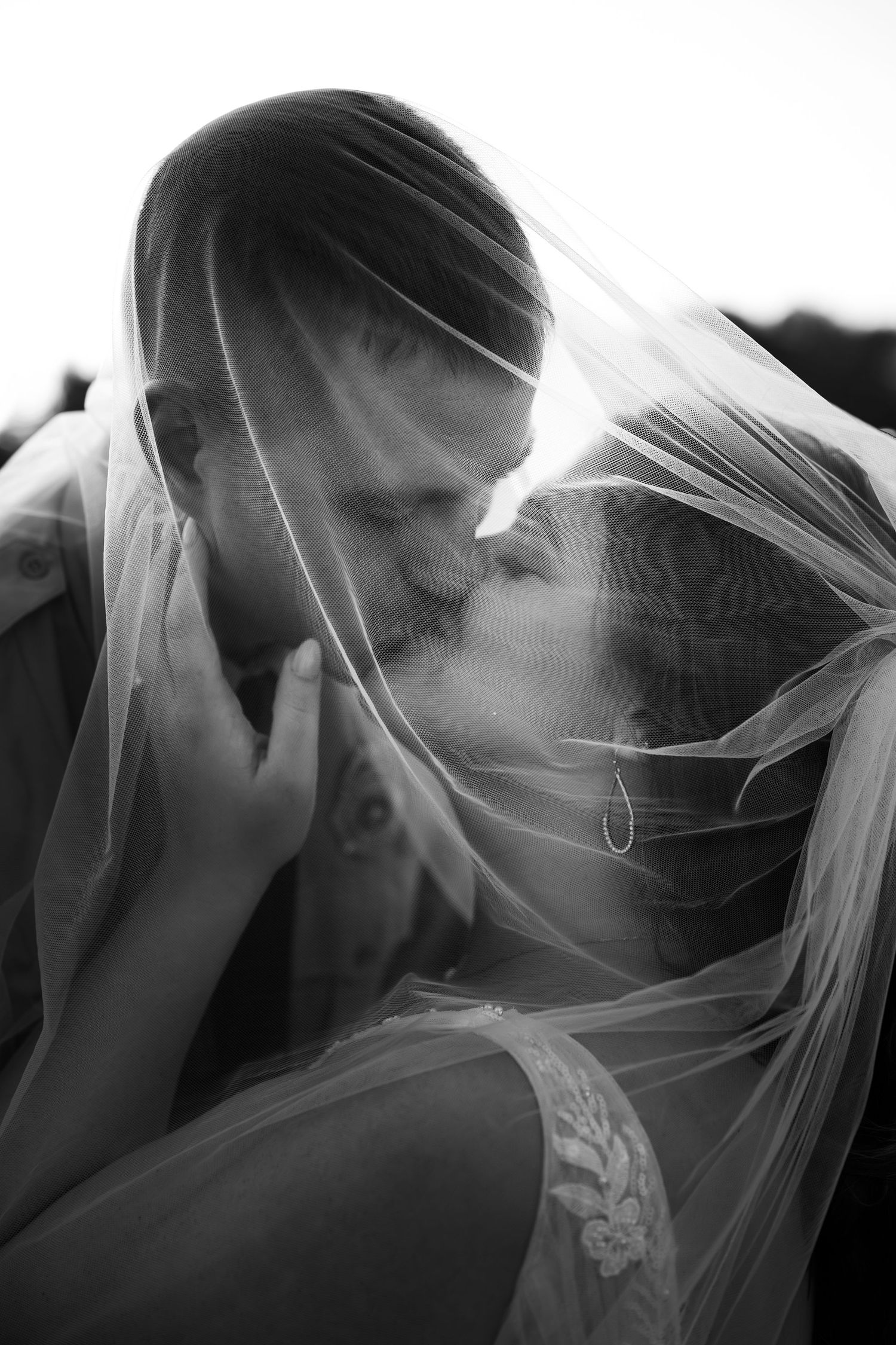 Artistic black and white wedding veil photos capturing intimate moments.