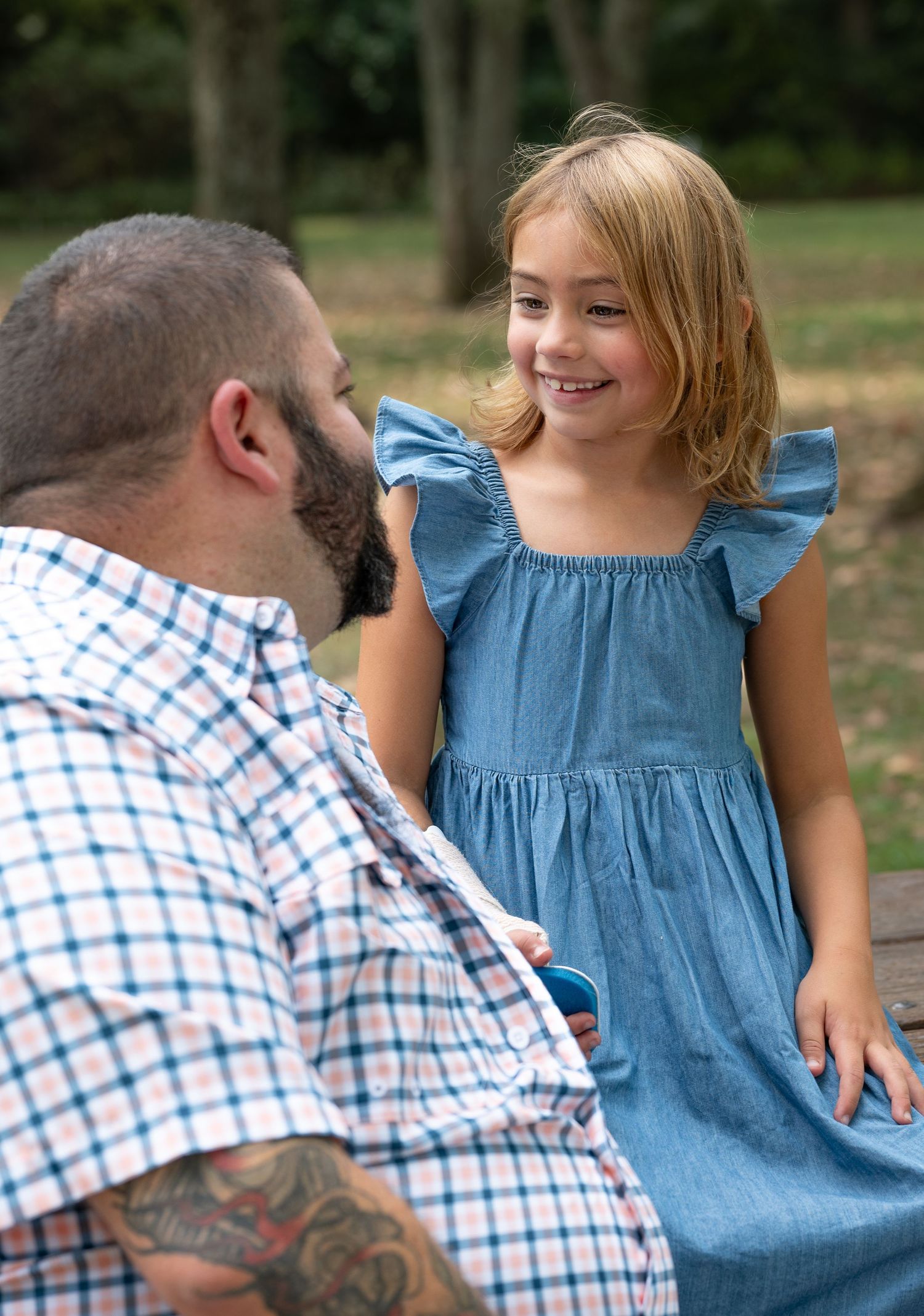 A series of candid outdoor photos showing a parent and child sharing playful moments together in a park setting.