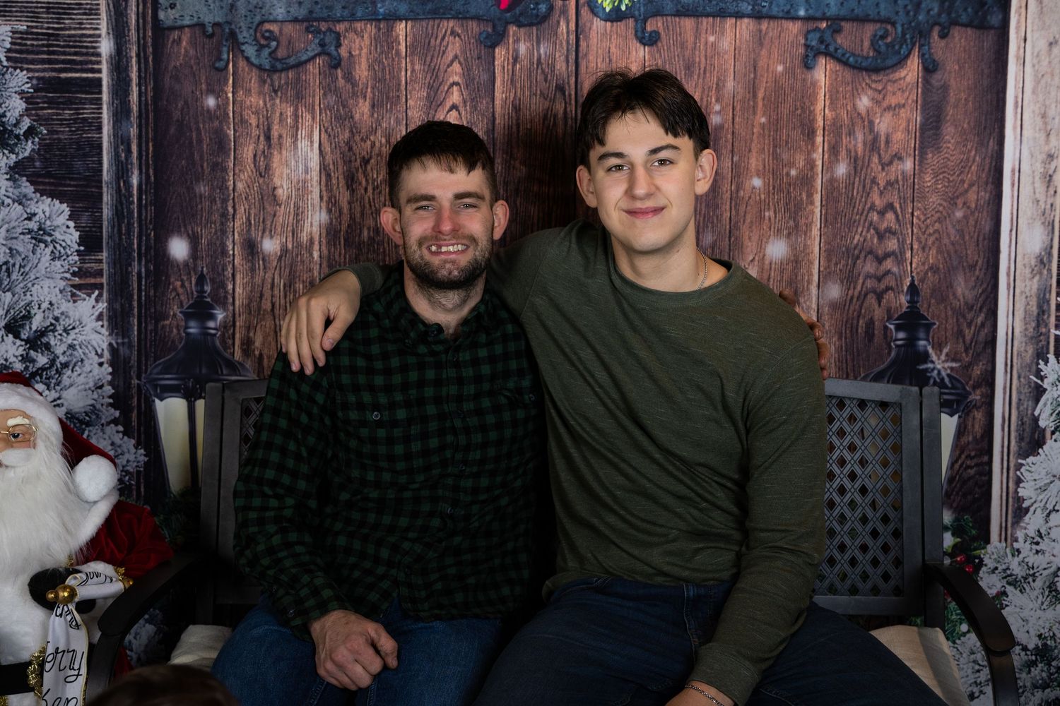 Winter portrait setup with rustic wood background and holiday decorations.