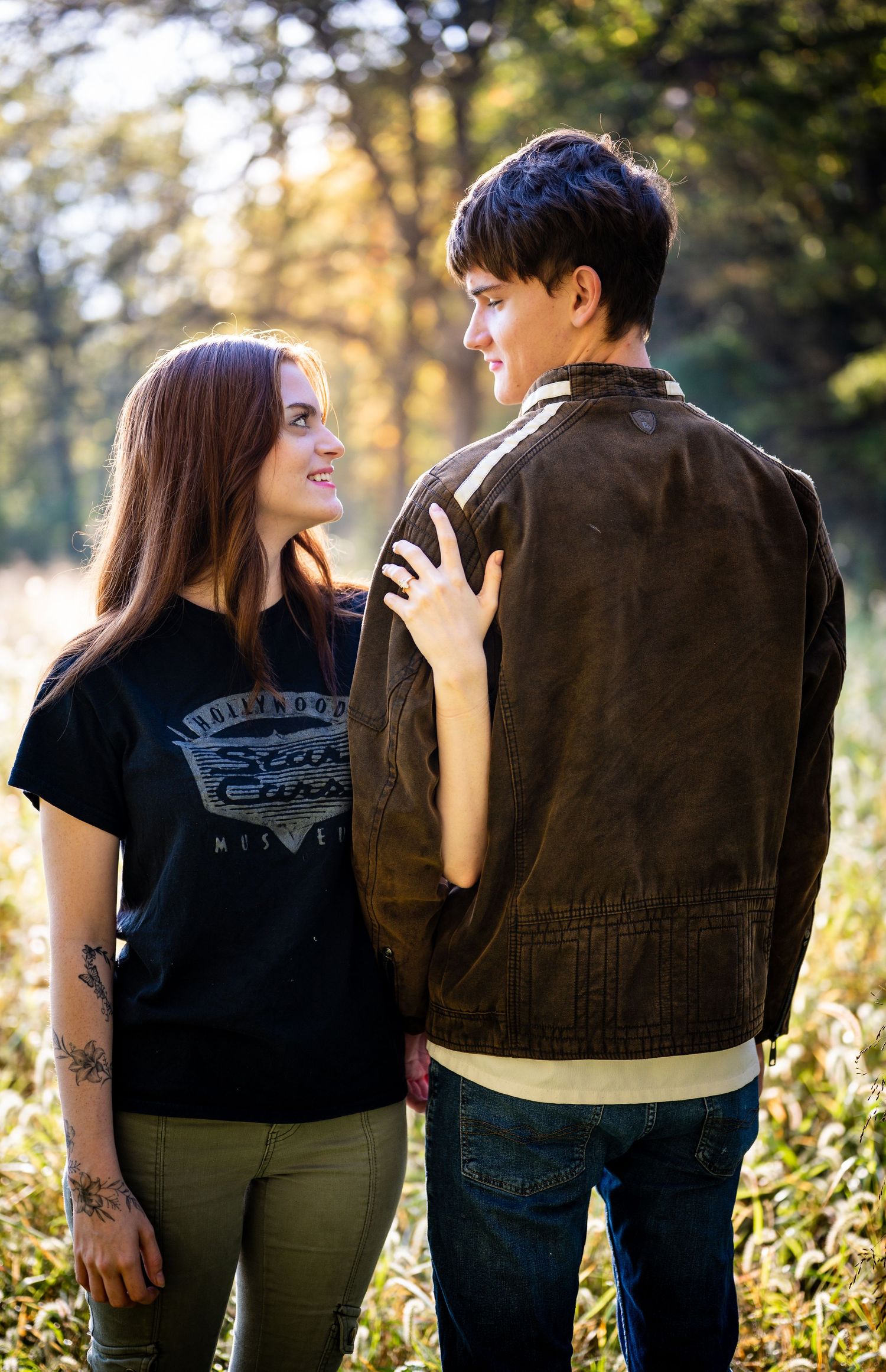 Three sequential photos of a couple in casual clothing standing together in golden sunlight among foliage.