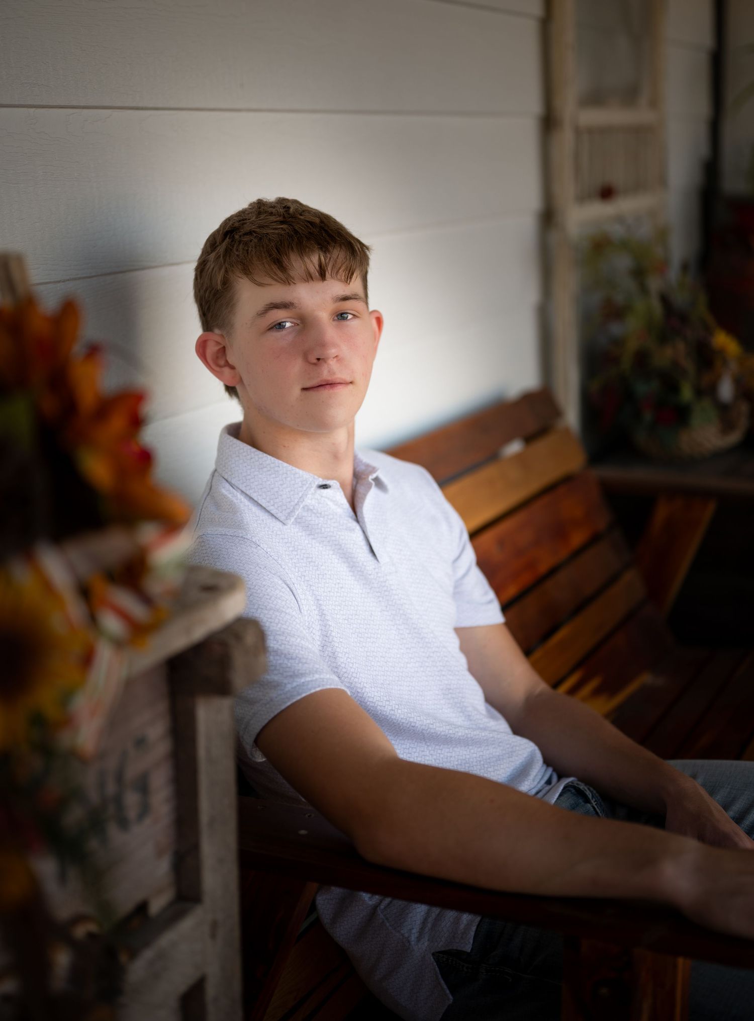 A person in a white button-down shirt sits on a wooden bench in a series of artistic portrait shots.