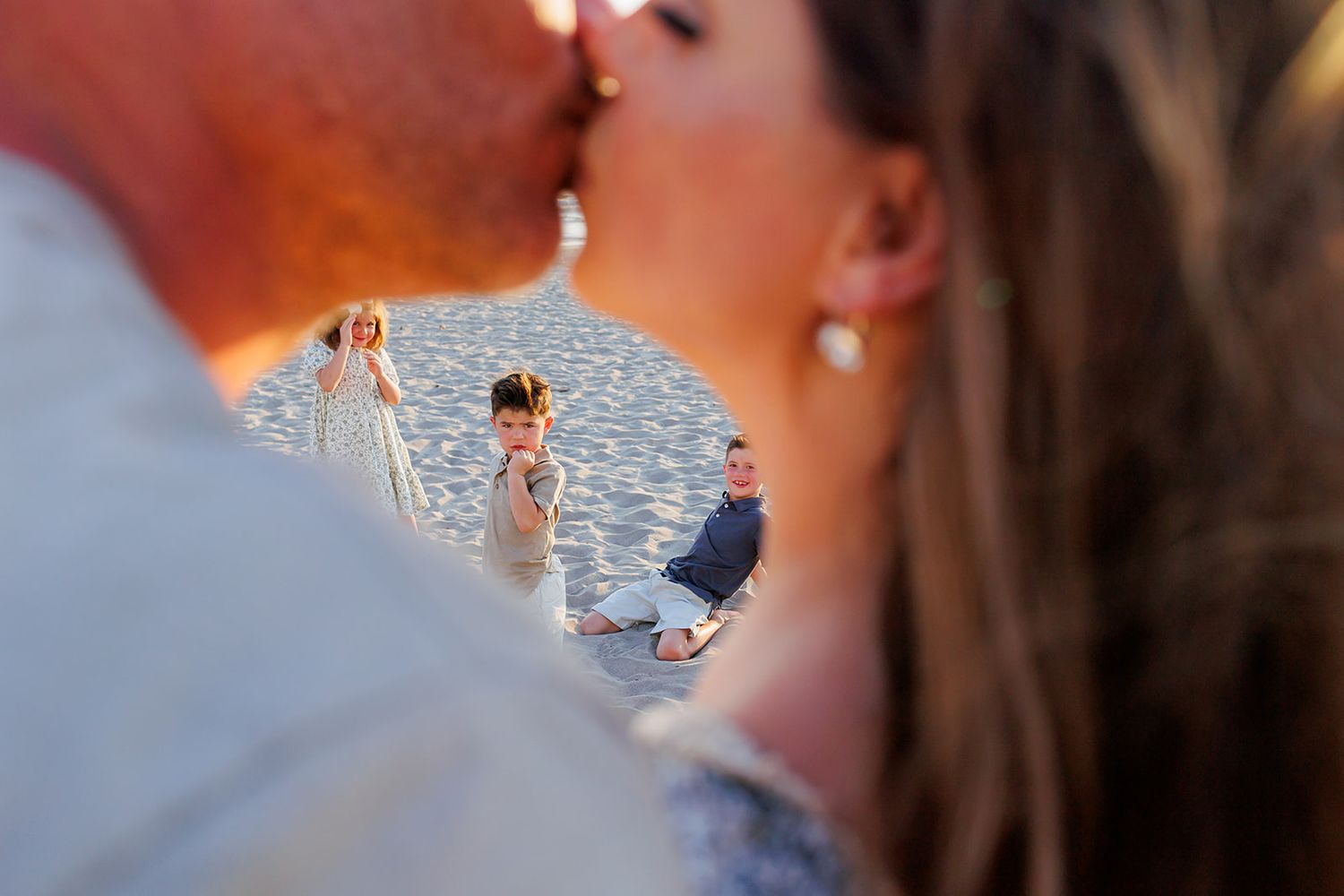 Candid family moment creatively framed during a beach photo session in Puerto Vallarta