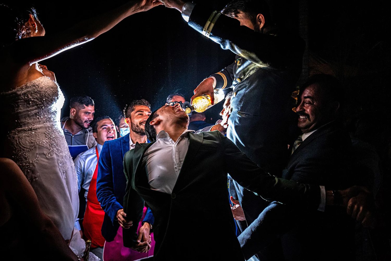 Groom and friends celebrating with tequila and laughter during a luxury destination wedding in Puerto Vallarta by José Carrillo.